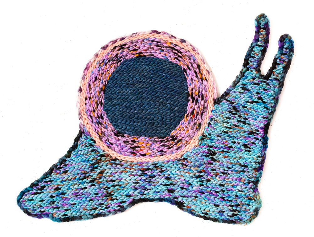 crocheted snail in pastel colors