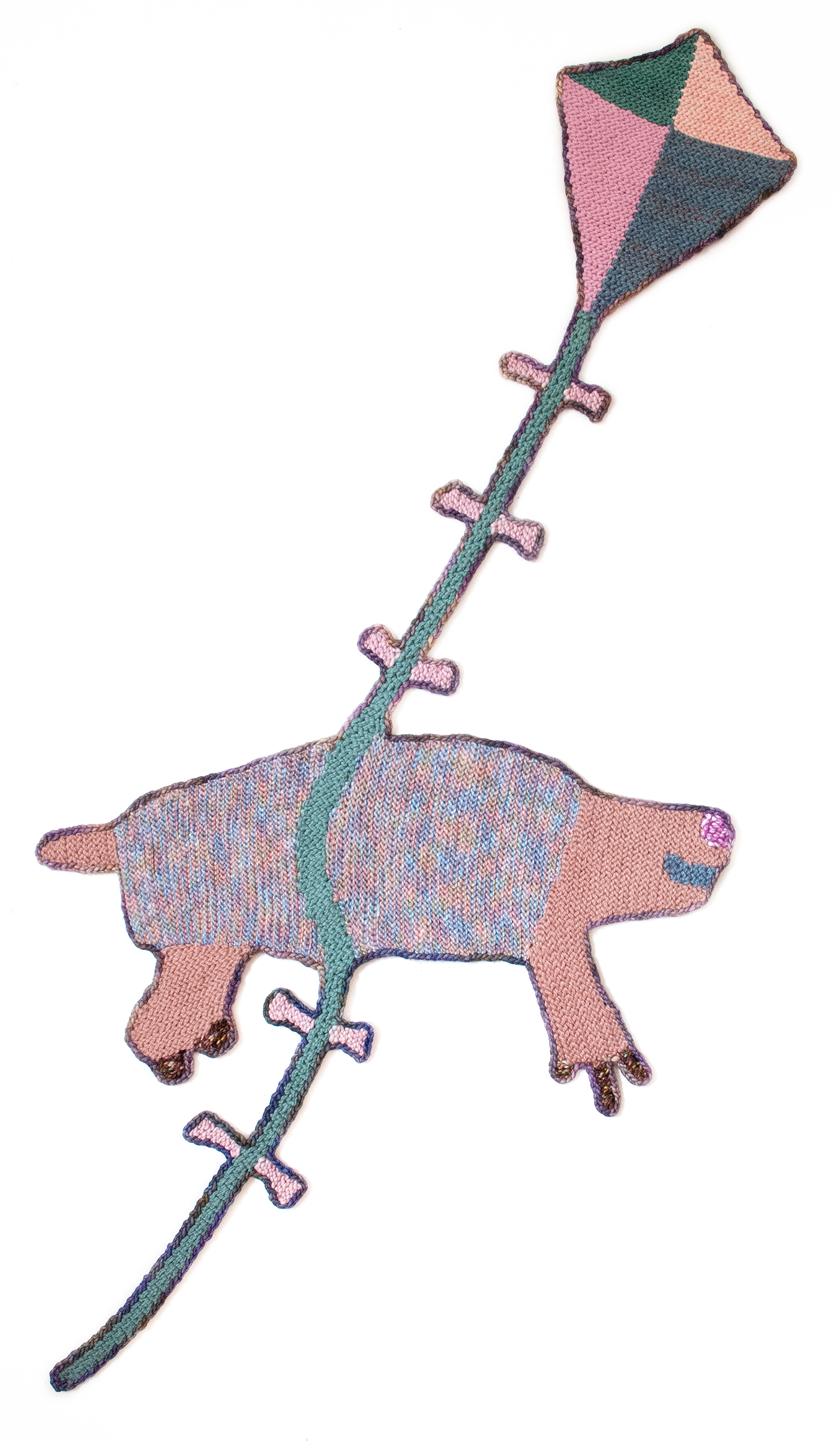 Pink crocheted animal being flown by a kite