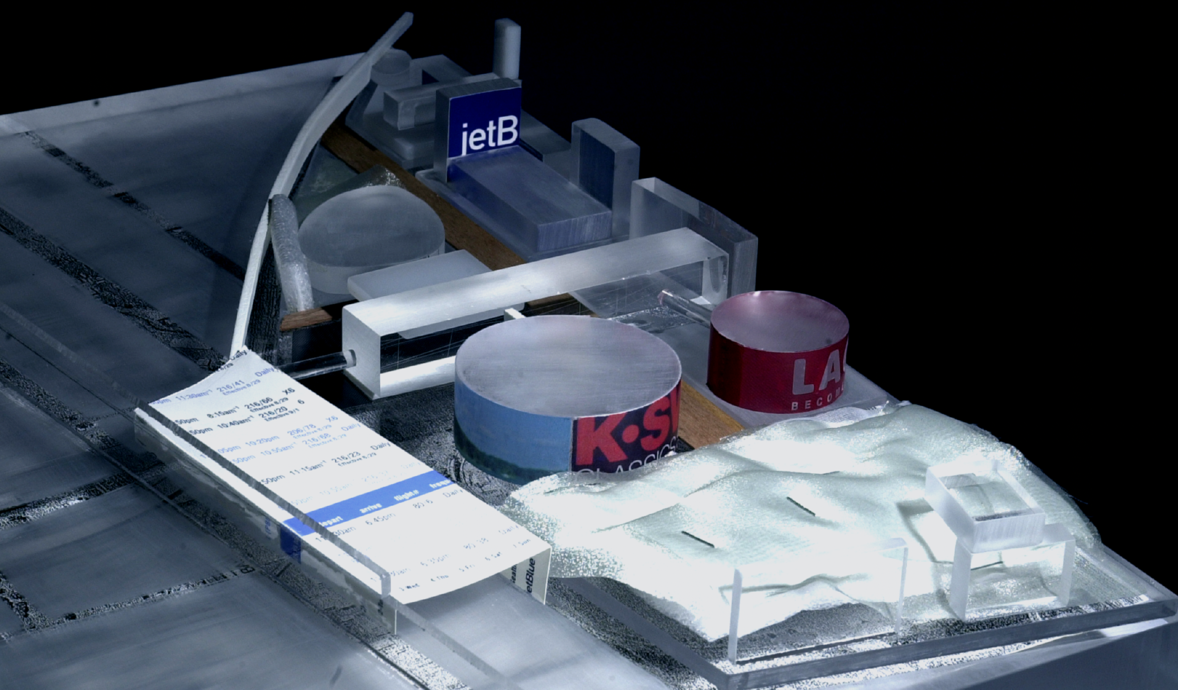 Front view of an architectural model with gray materials and cylindrical features in the center.