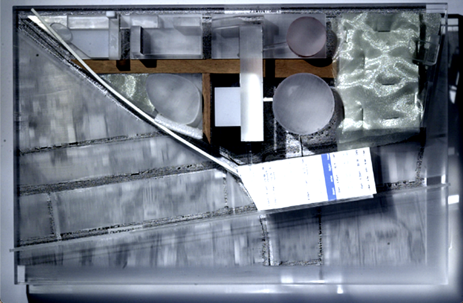 Top view of an architectural model with gray materials and cylindrical features in the center.
