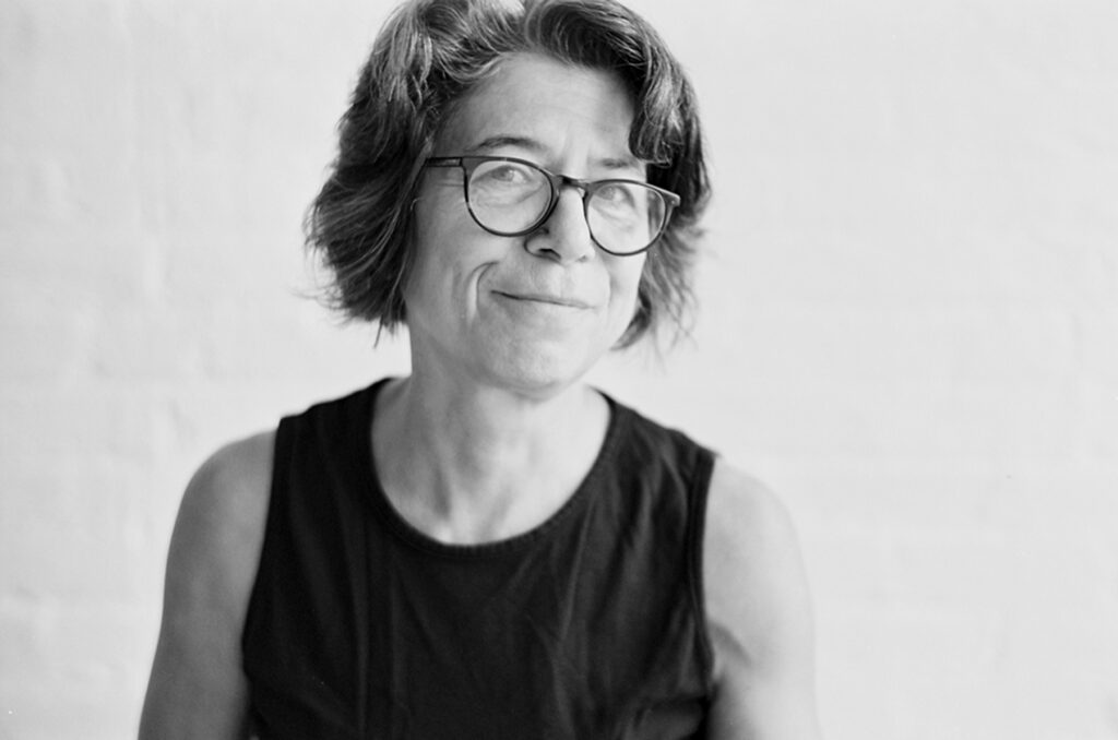 Black-and-white photo of a middle-aged woman wearing glasses.