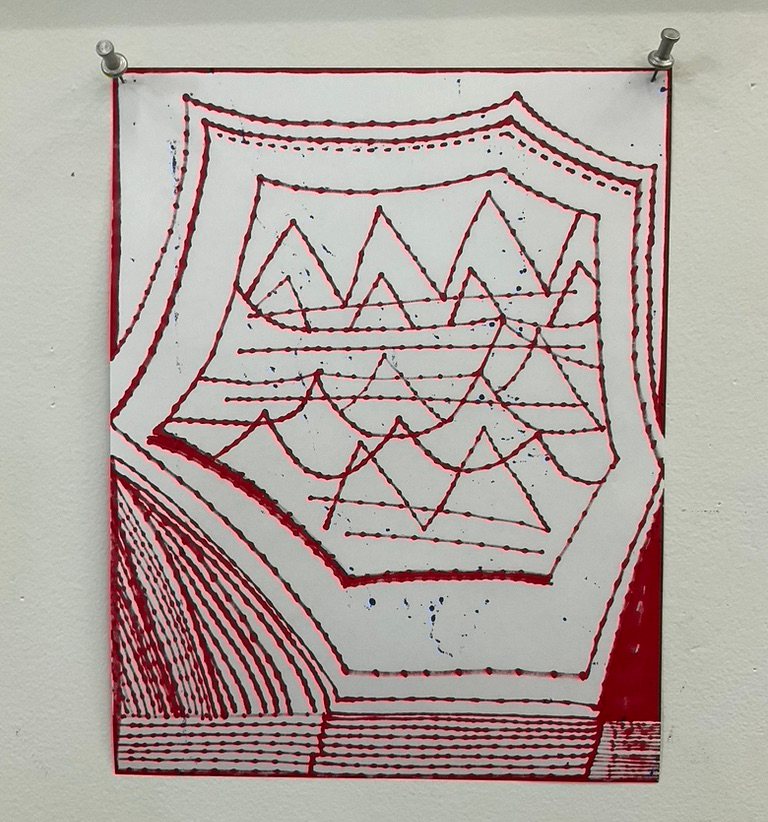 Painted red and white shapes on paper pinned to a white board