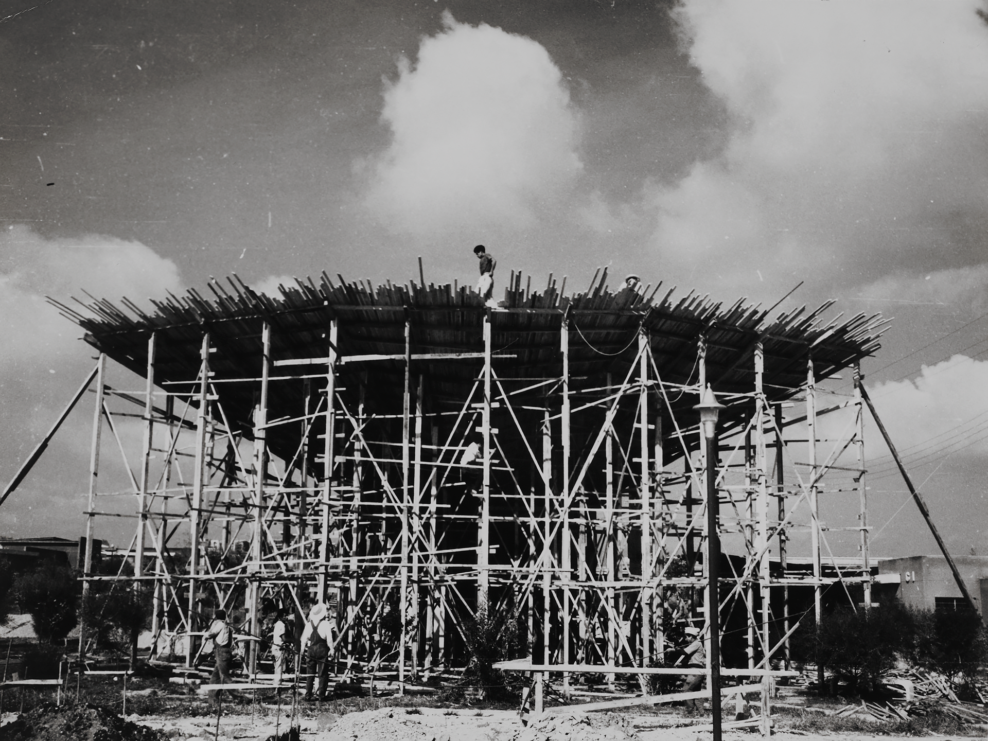 Wood formwork under construction with workers visible