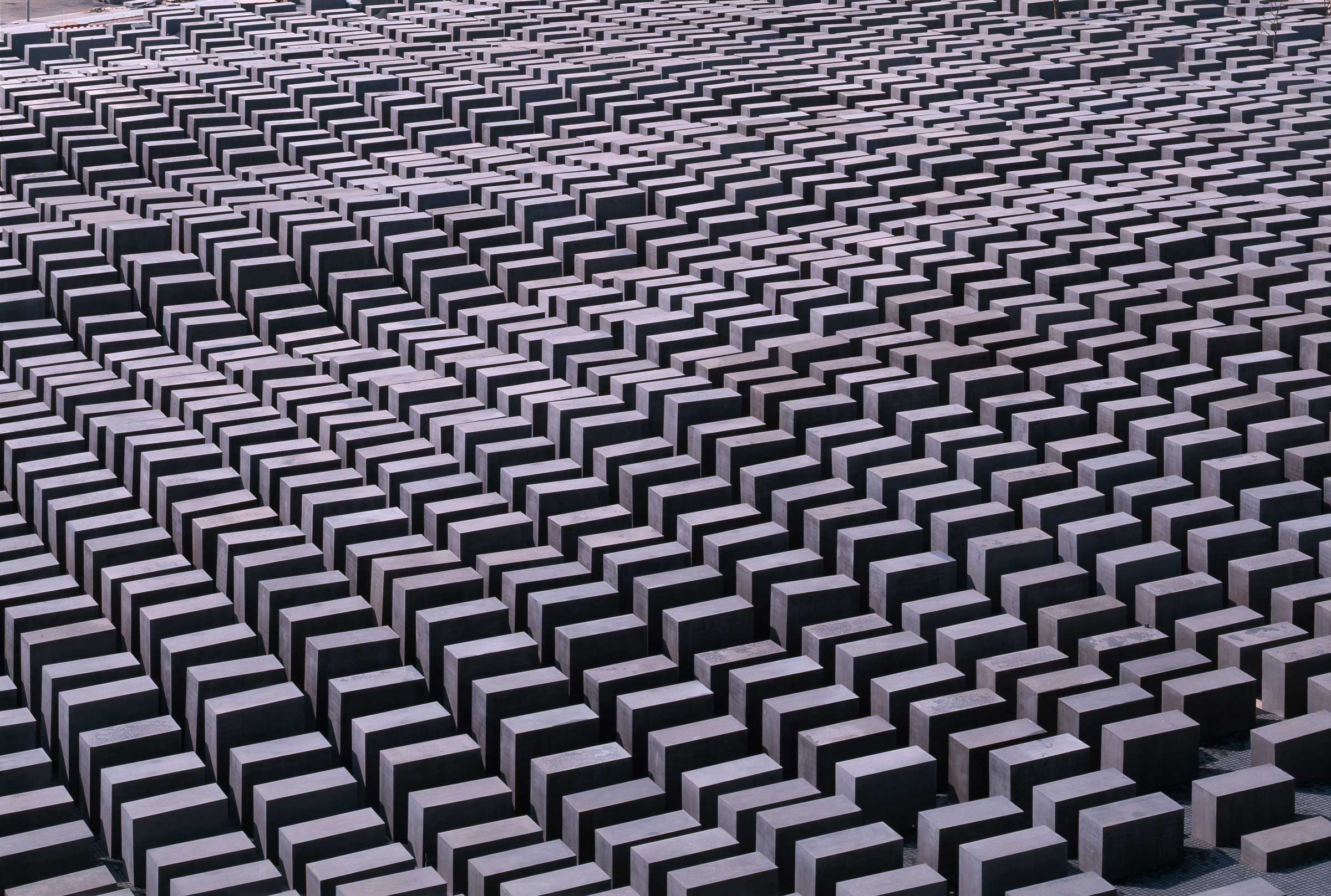 Aerial view of the Berlin Memorial showing a rigid grid structure composed of large concrete pillars.