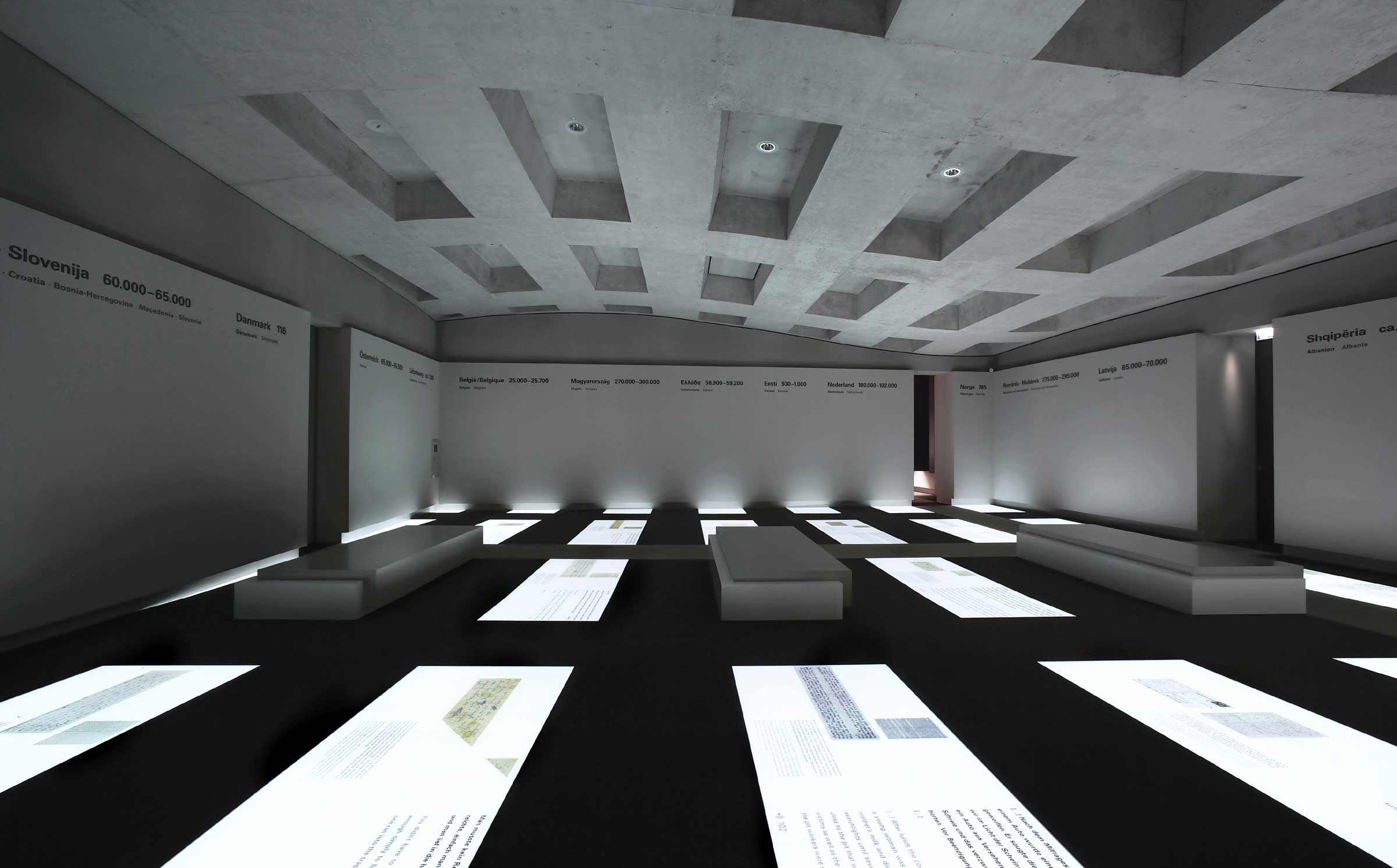 Interior of the Berlin Memorial where rectangular projections mirror the exterior concrete pillars.