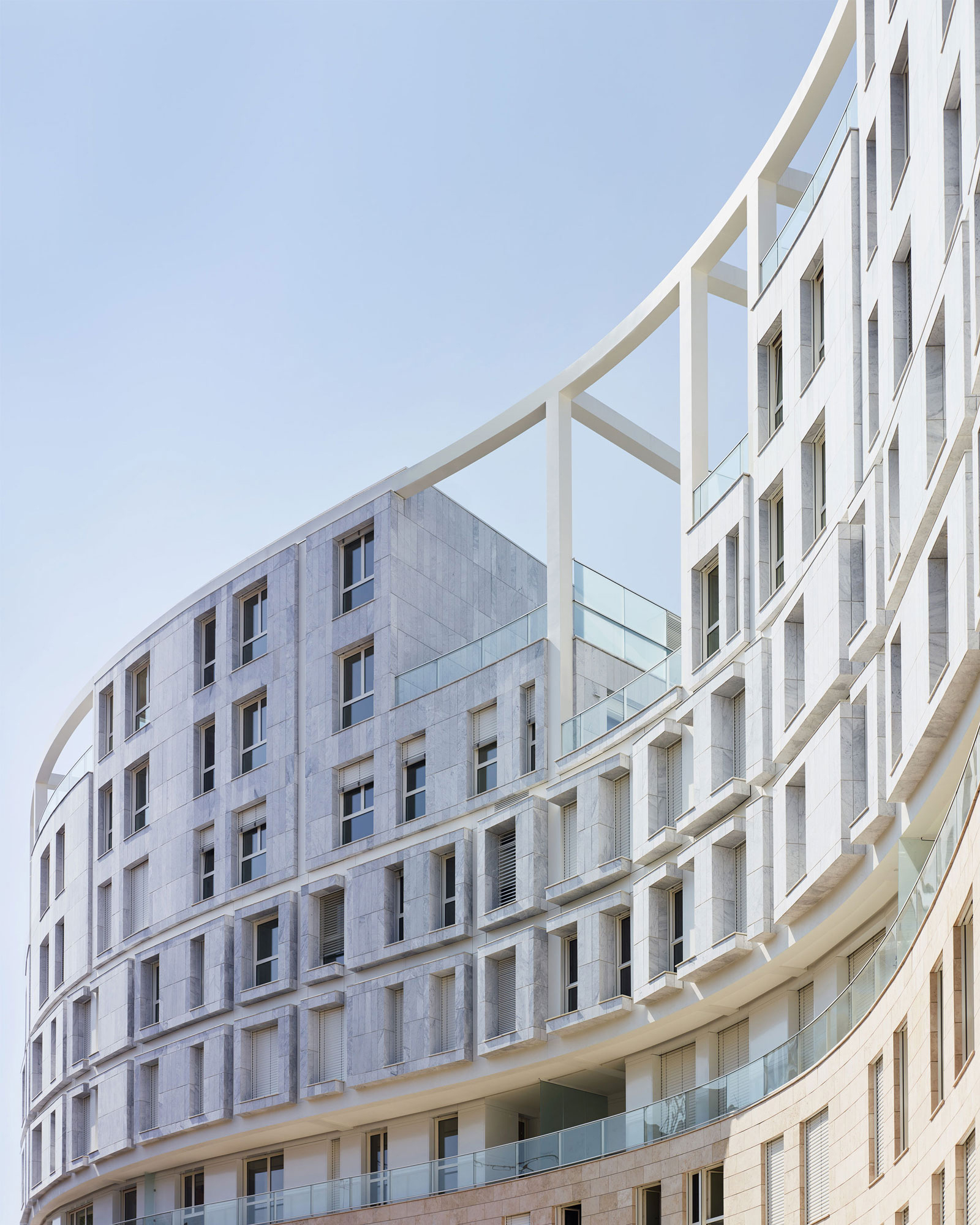 Exterior view of a building wall with a gentle s-curve shape.