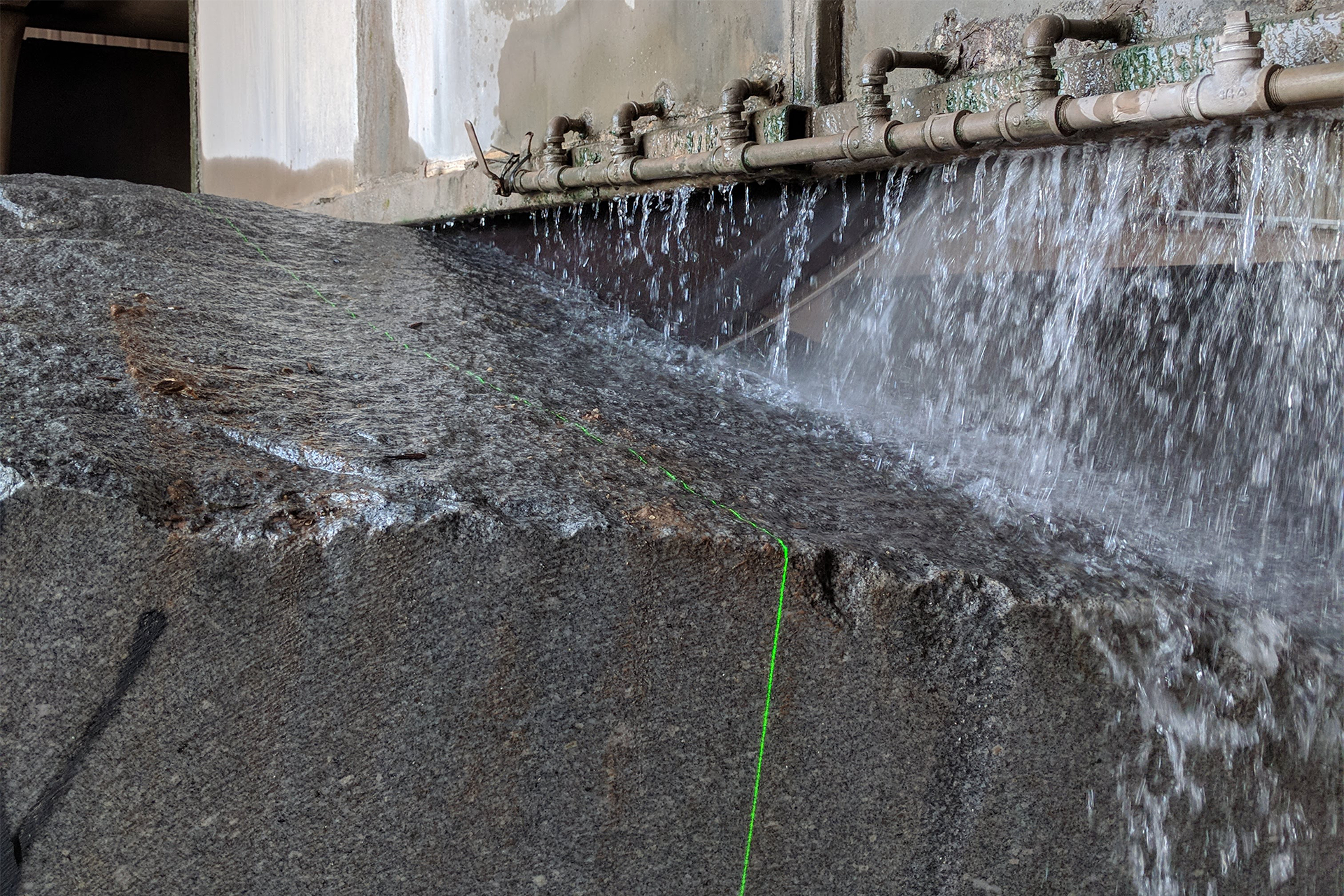 Water falling on large stone during cut