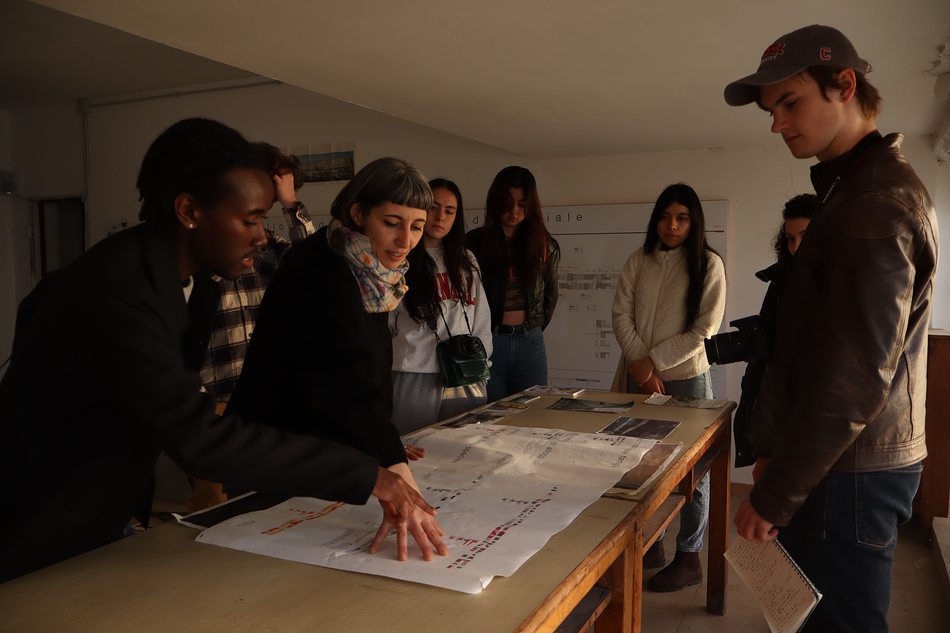 People gathered around a table in discussion.