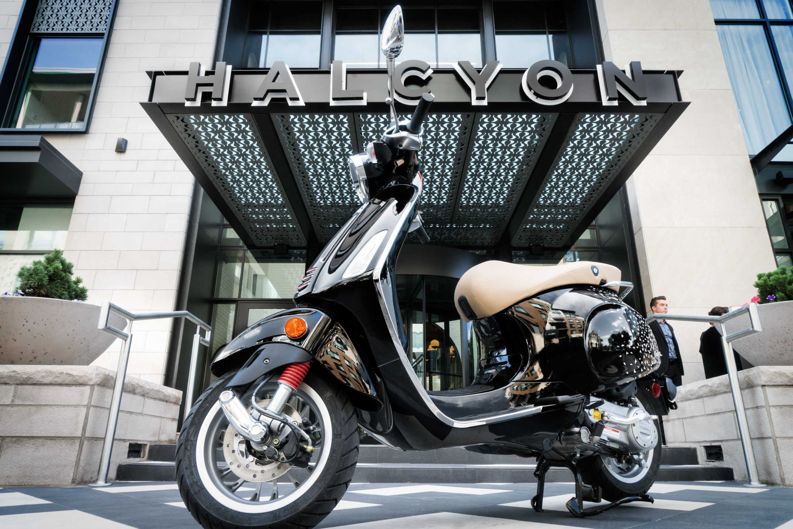A moped is parked outside the Halcyon hotel