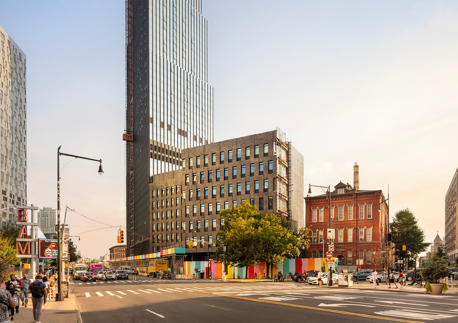 City intersection filled with people, buildings and high-rises