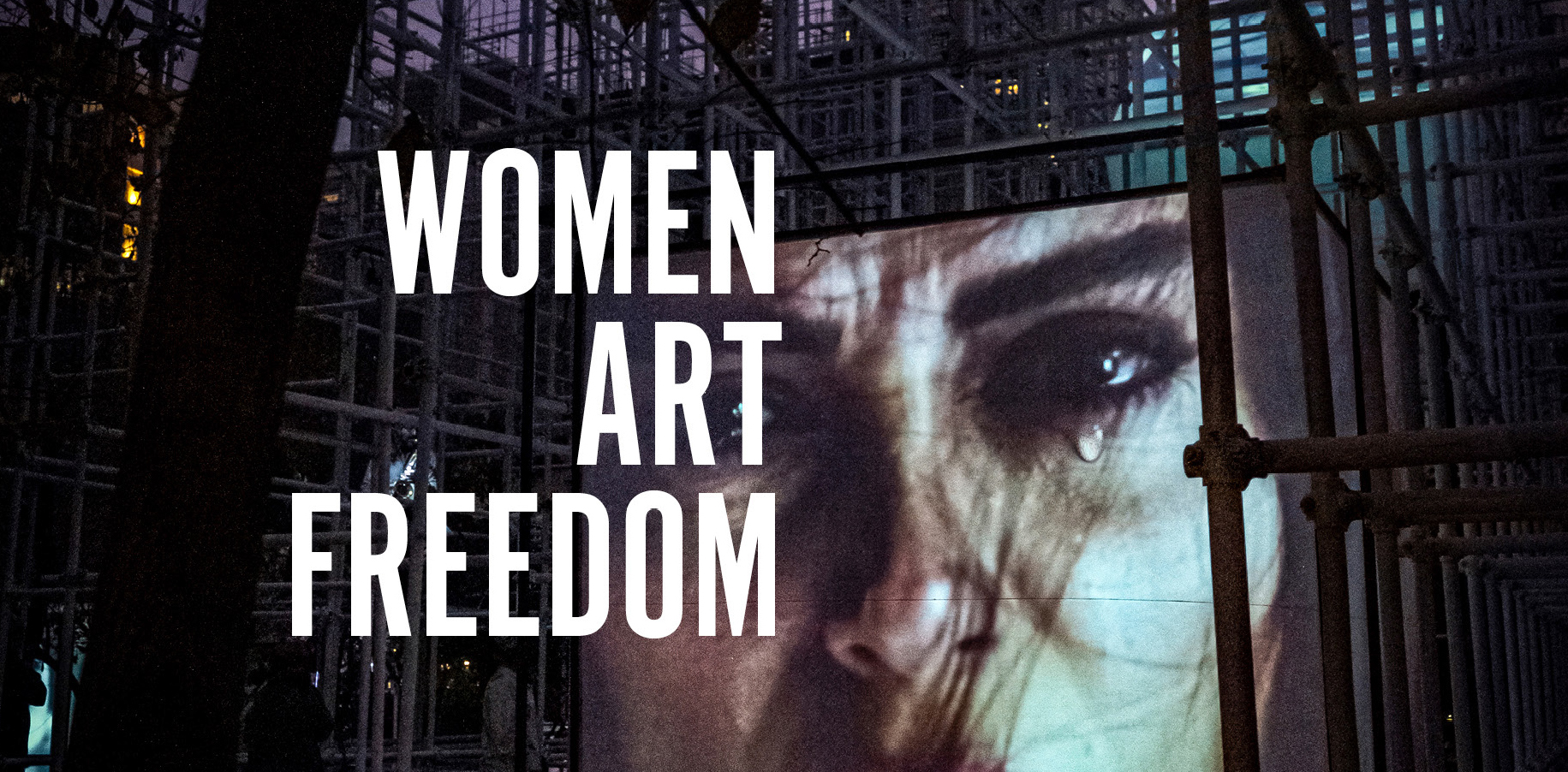 Book cover featuring video projection of a woman's face with a tear and the text Women Art Freedom