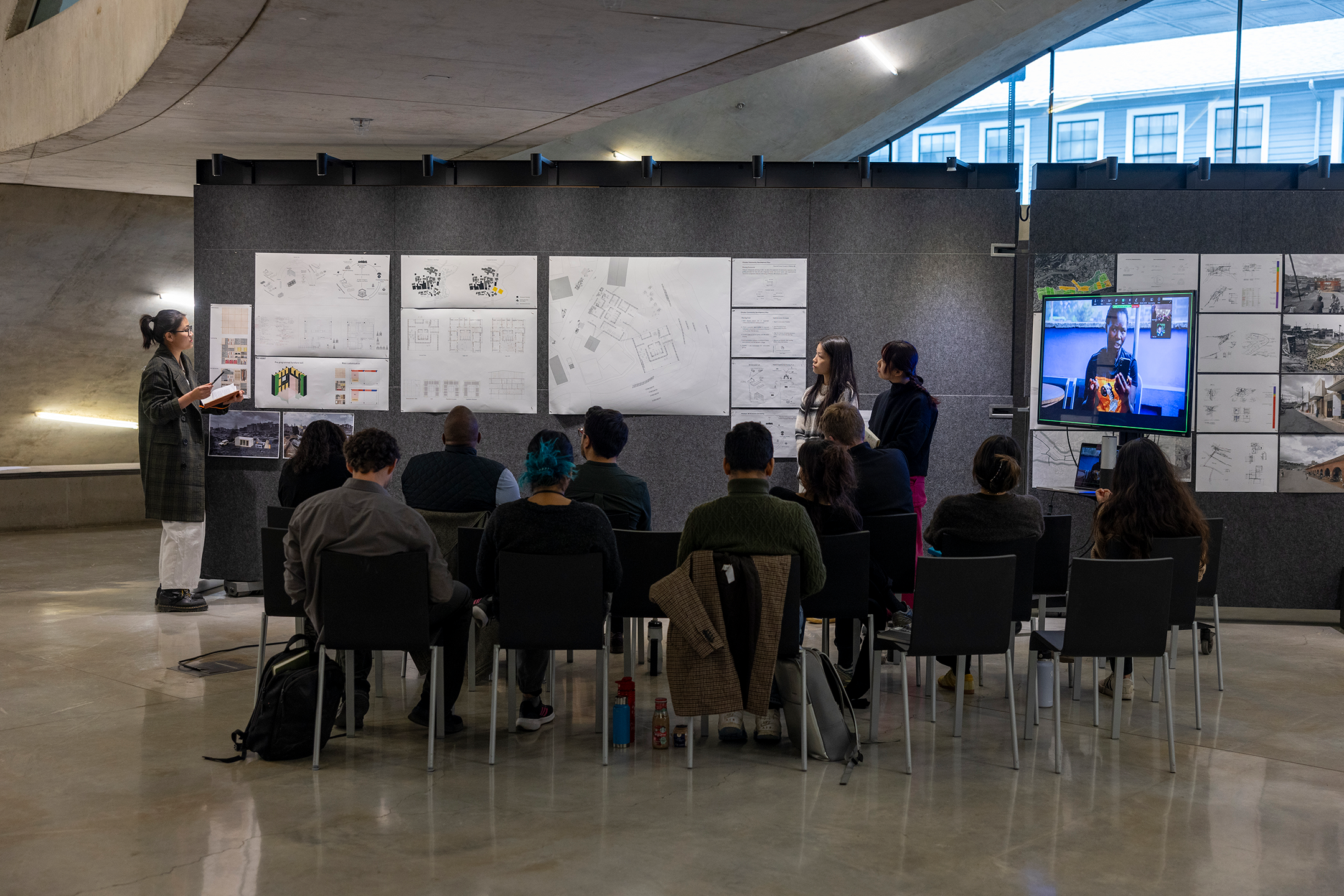 Students presenting work for review.