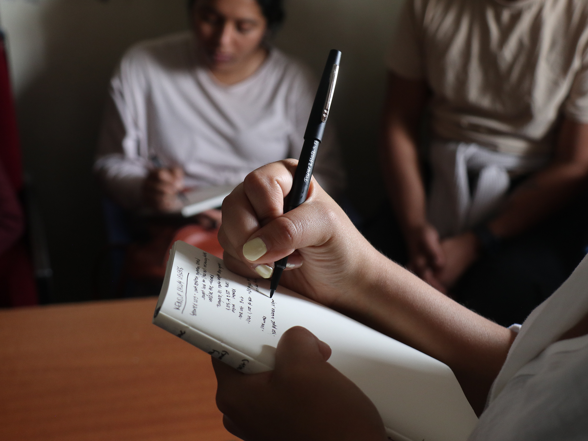 student taking notes in a notebook