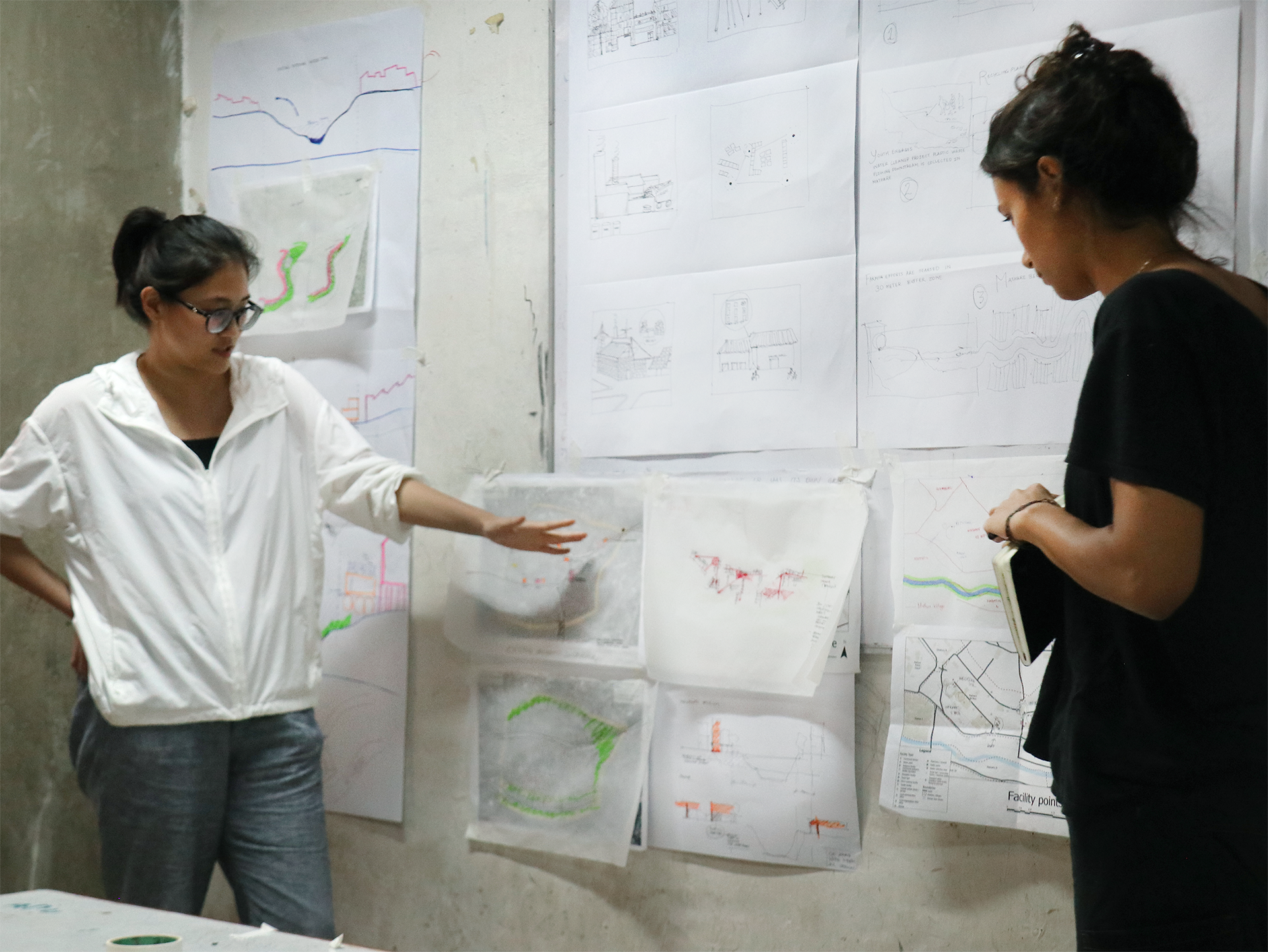 Students presenting in front of a pin up board