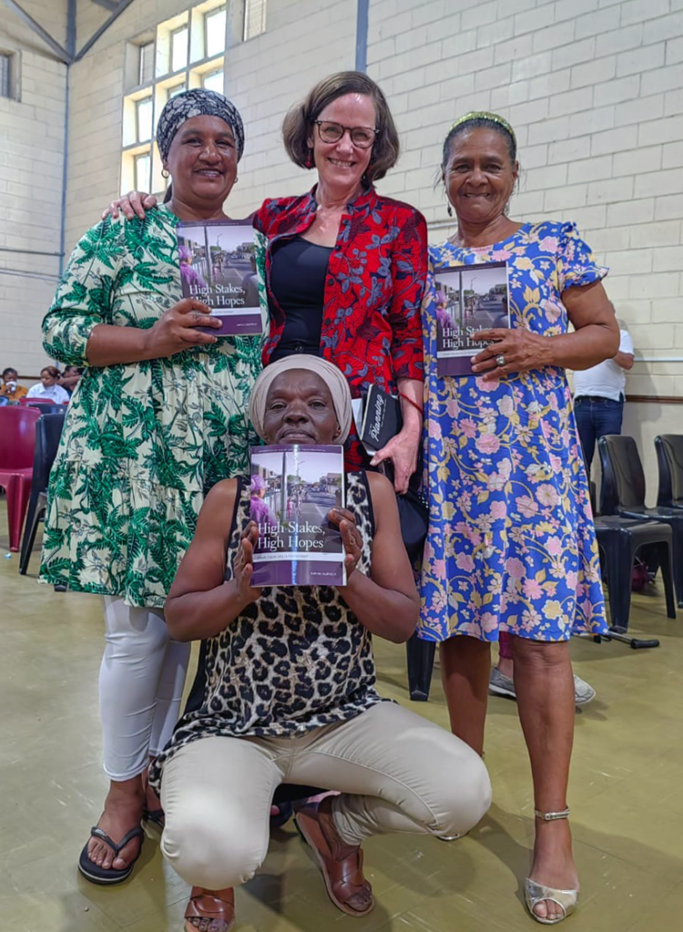 Group of women posing with book