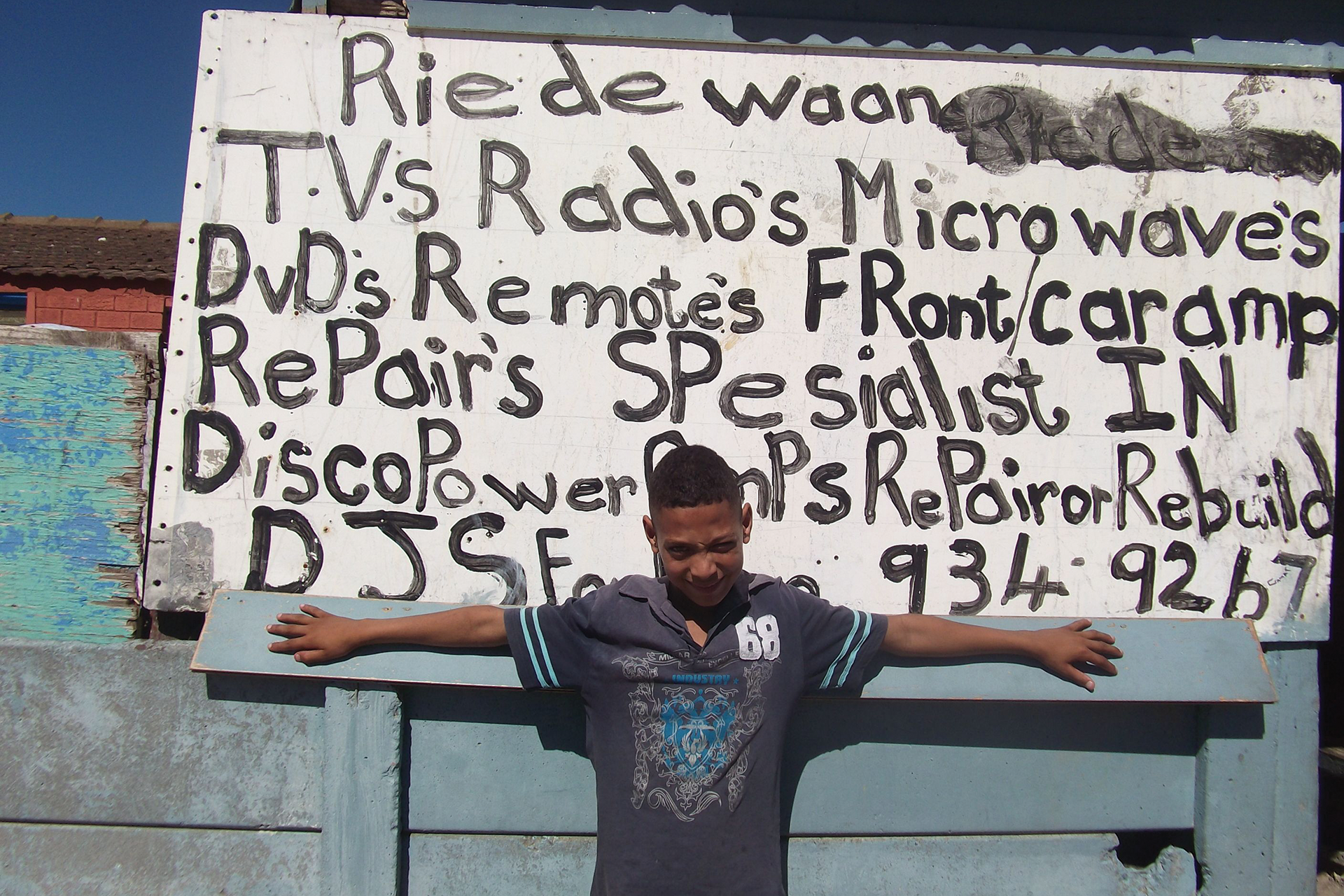 boy in front of business sign