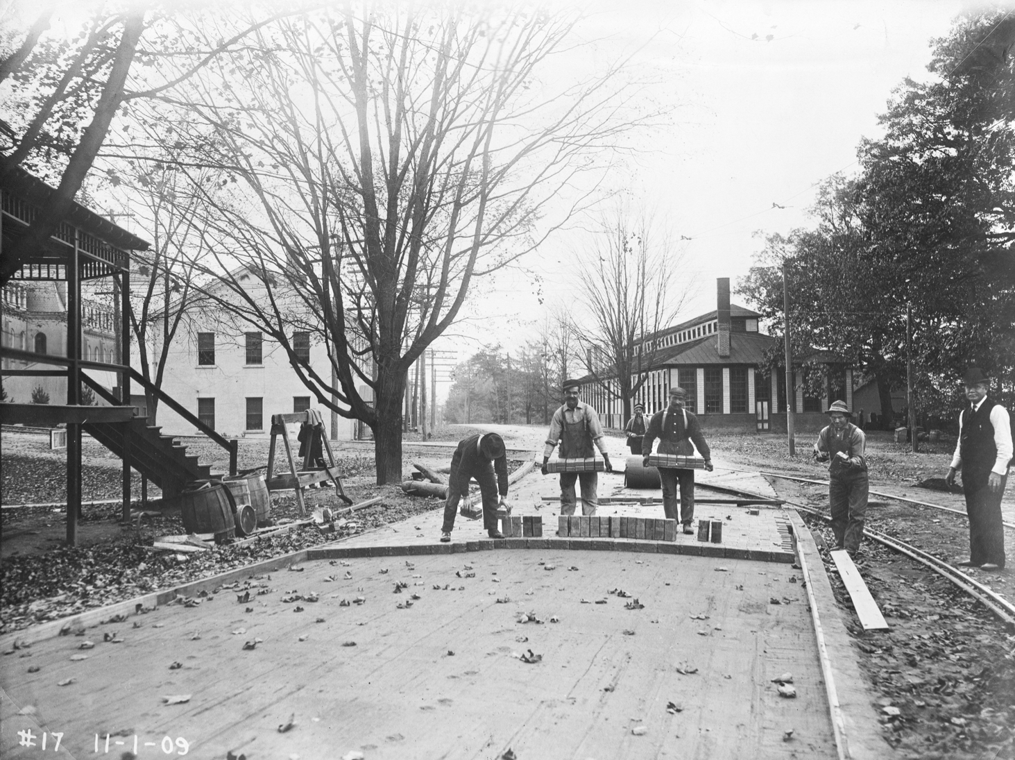 Historic image of workers moving bricks
