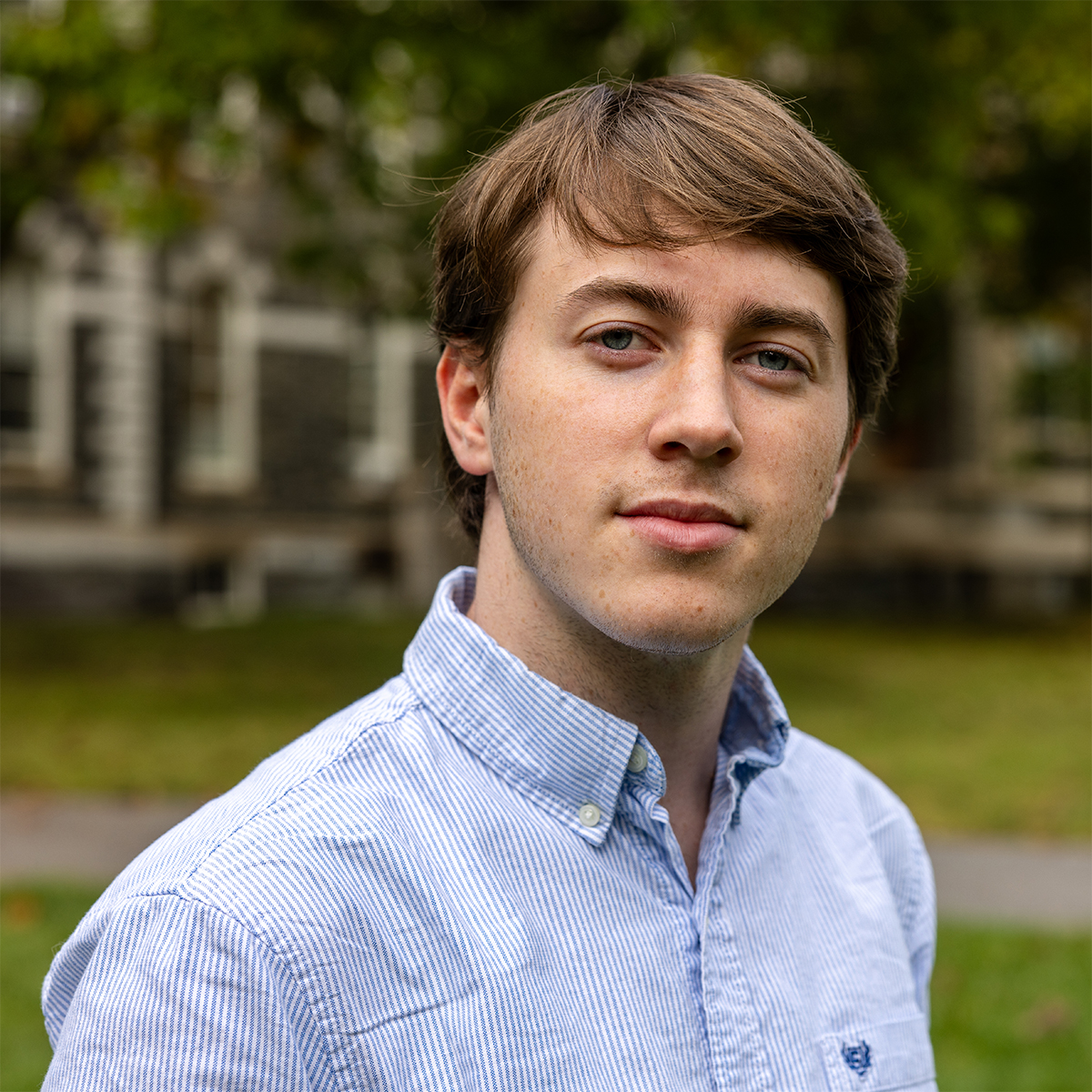 A person wearing a light blue button down shirt.