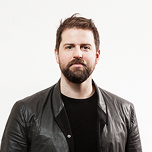 A man with brown hair and a brown beard