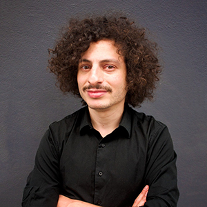 A man with brown hair and a mustache