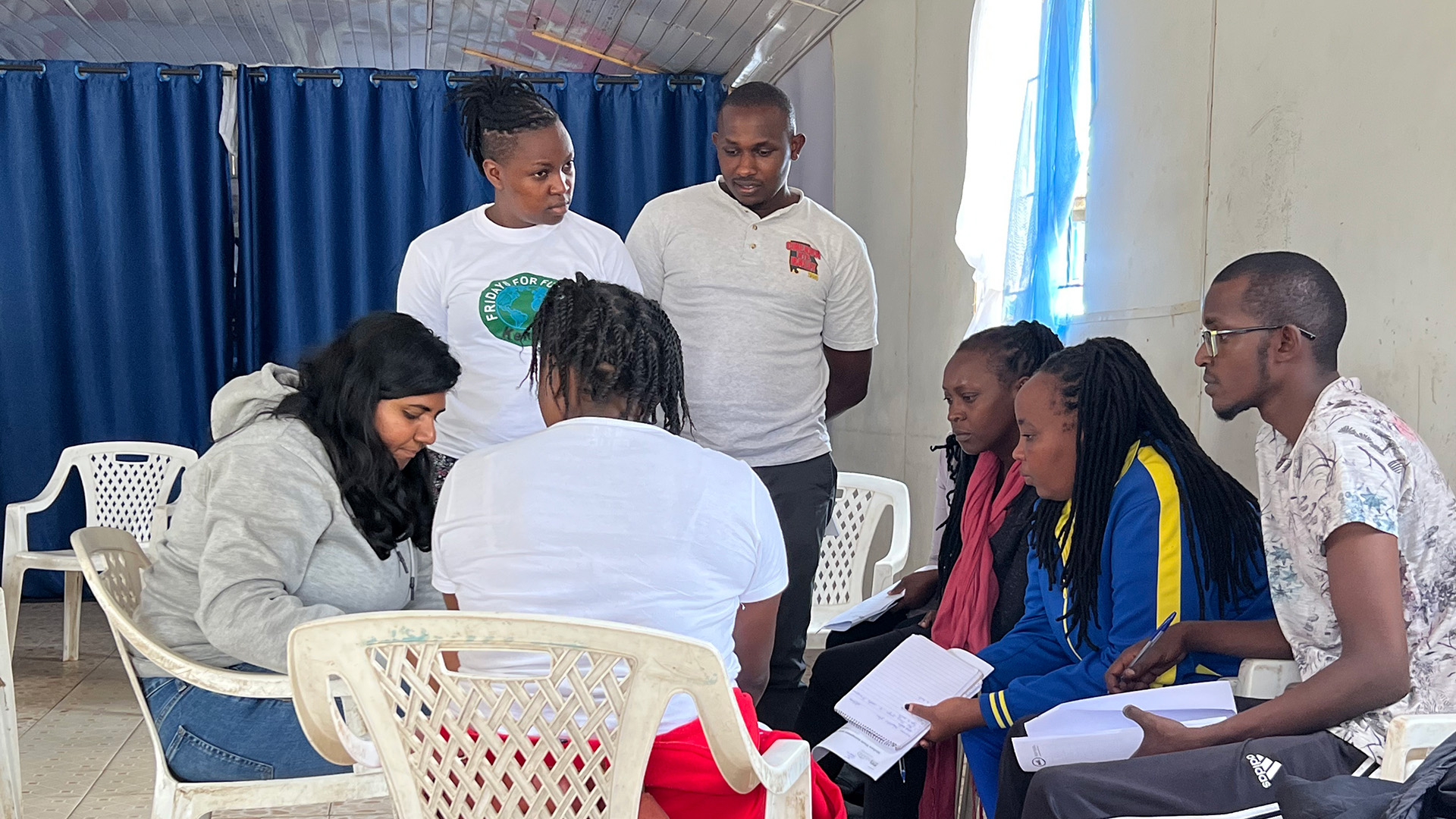 People standing around and sitting in chairs.