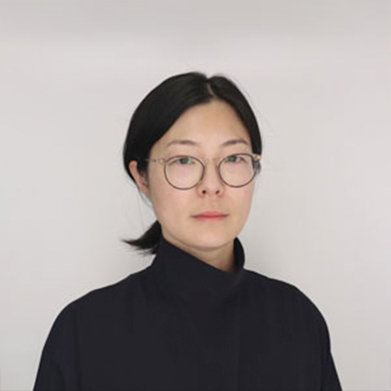 Headshot of a person with short black hair