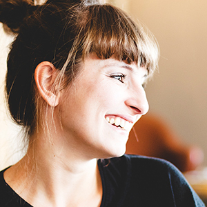 profile of a person with hair pulled up in a bun.