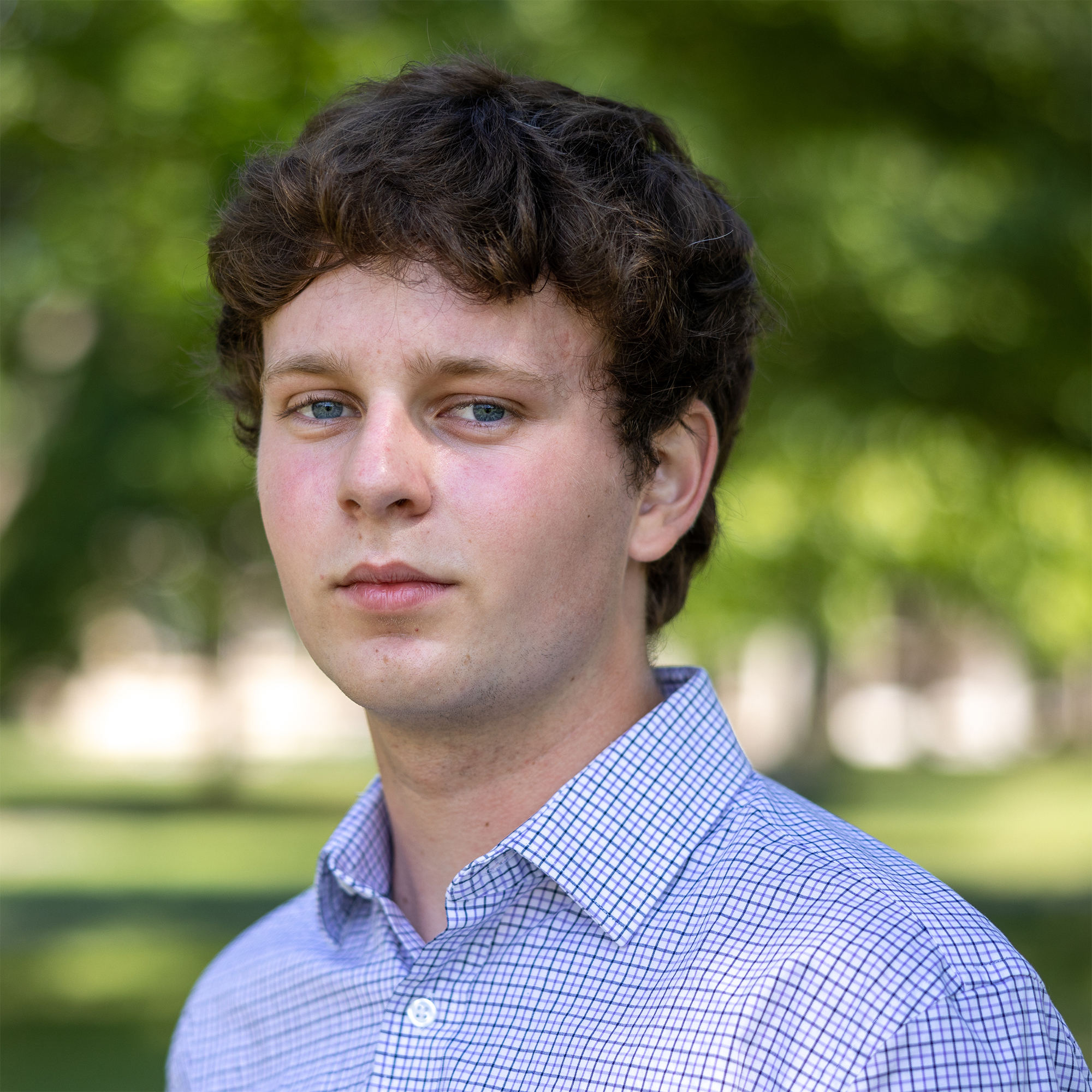 Person wearing checkered blue collared shirt
