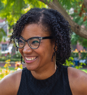 Smiling woman with a back sleeveless shirt and eyeglass on