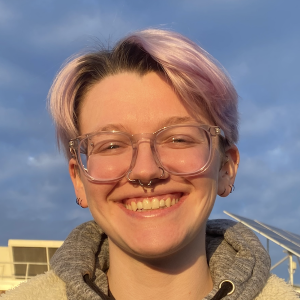 A person with short light purple hair