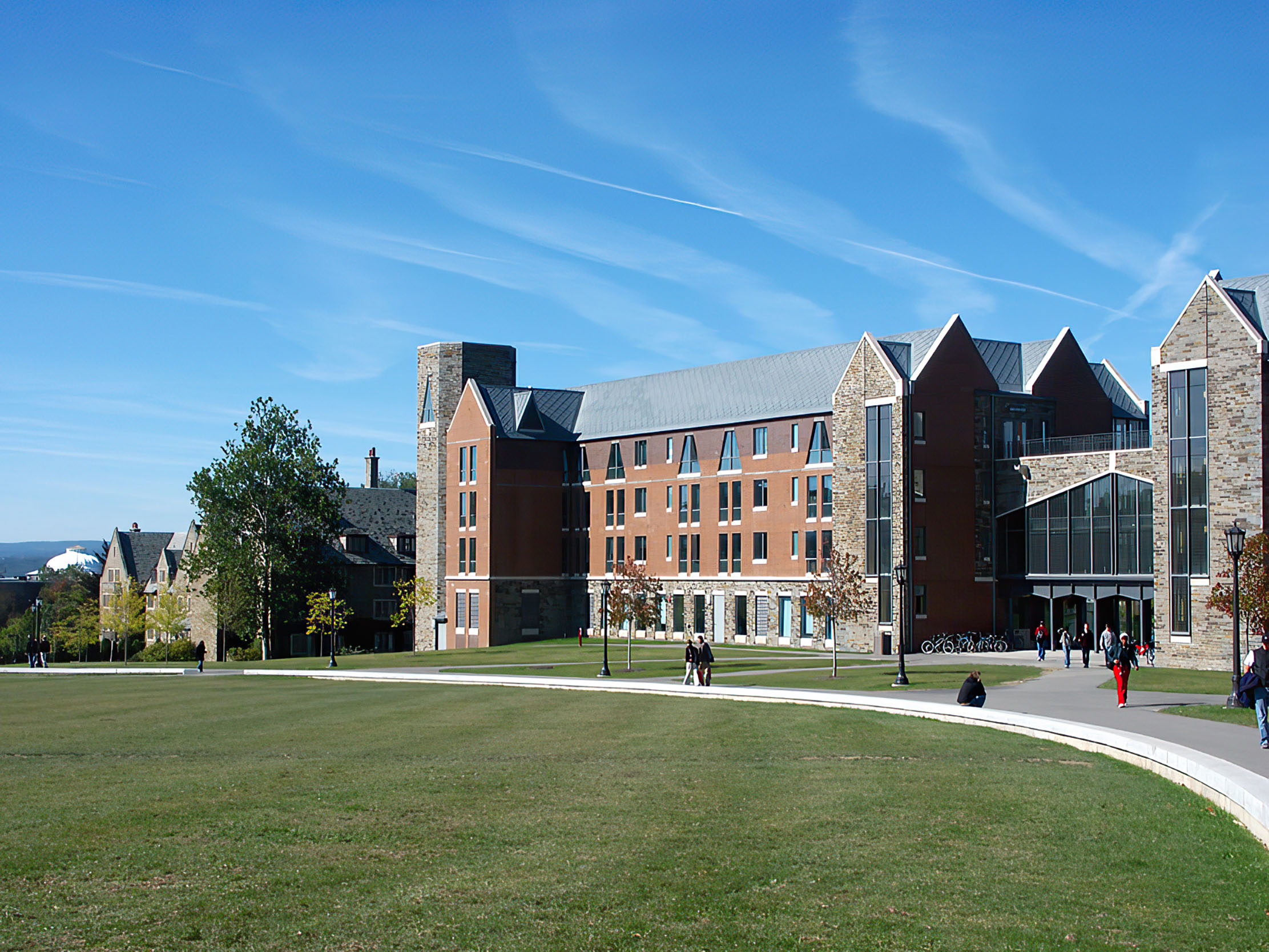 Courtyard in front of a red brick and stone-brick colored building.