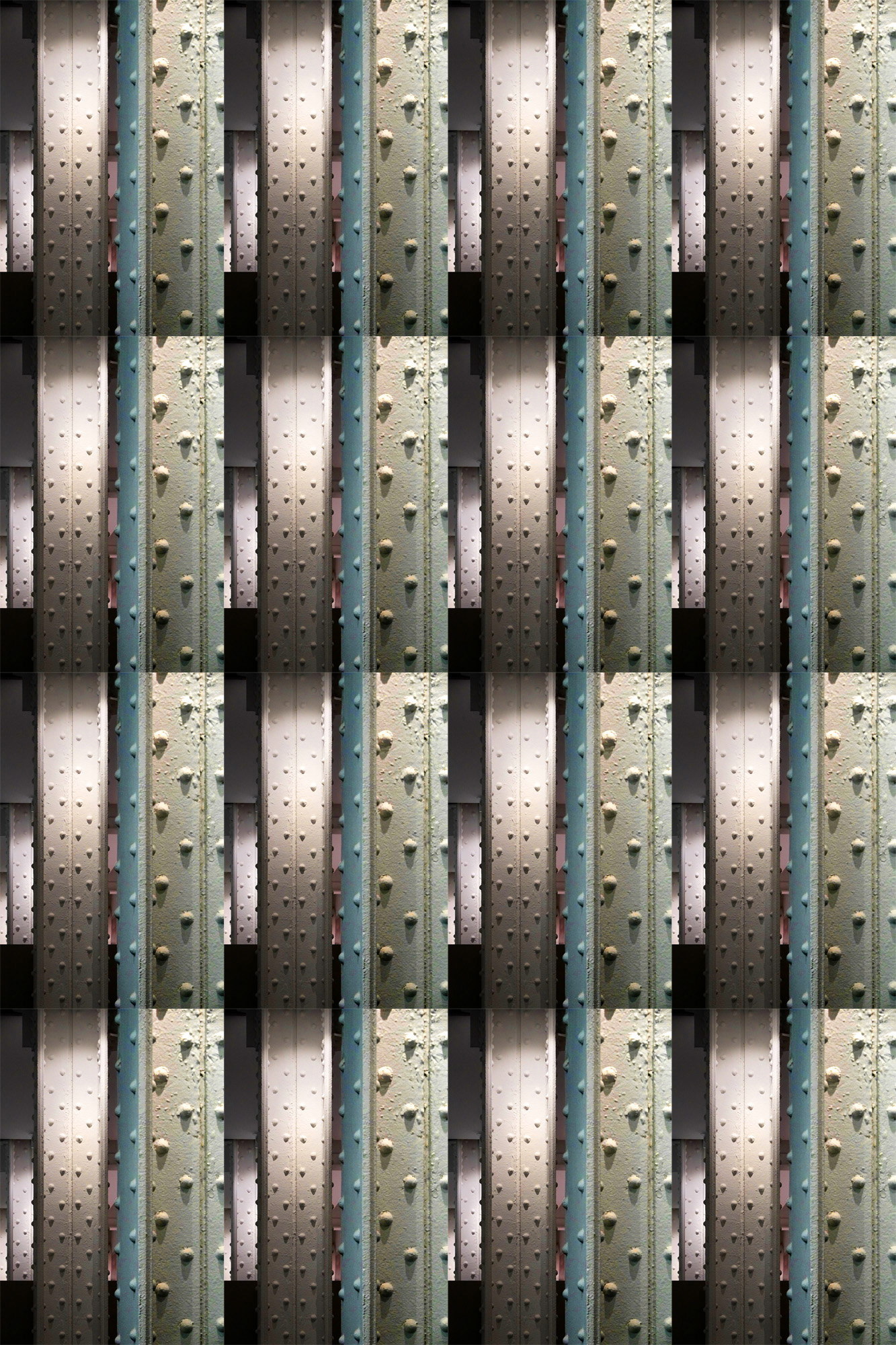 Photograph of concrete strips dotted with rivets.