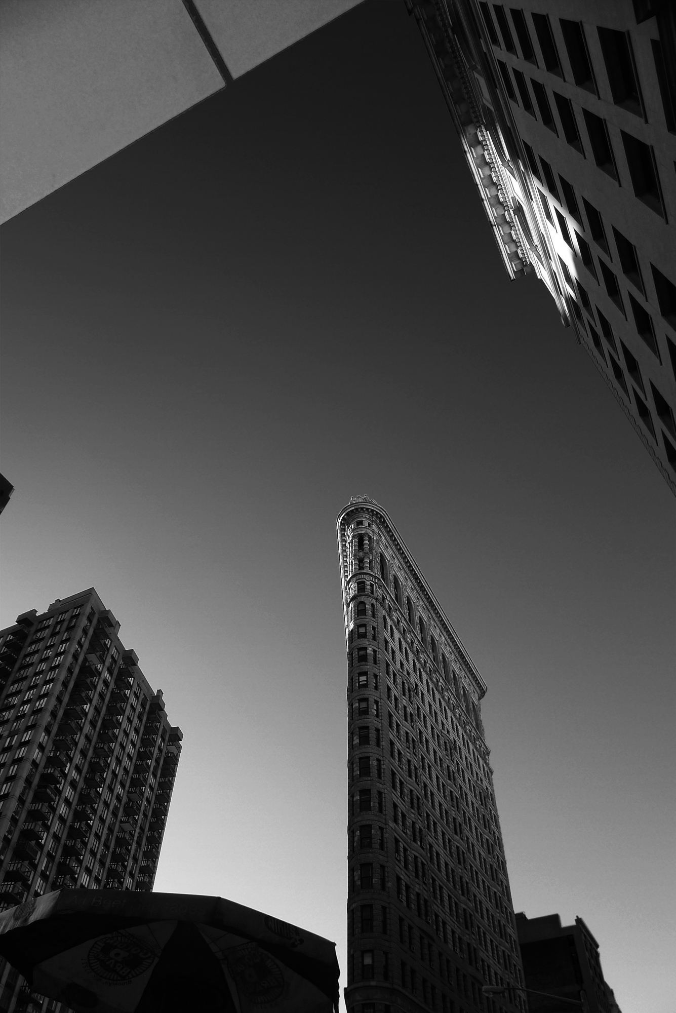 looking upward at NYC's Flatiron and surrounding buildings.