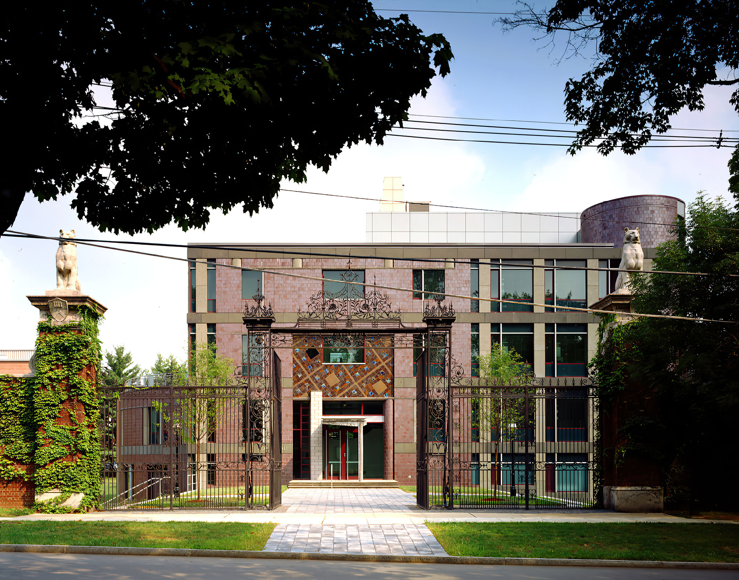 Brick exterior of a building behind an ornate gate
