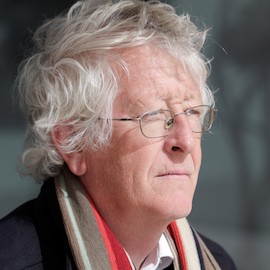headshot of a man with white hair