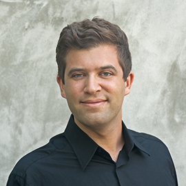 A man wearing a black collared shirt