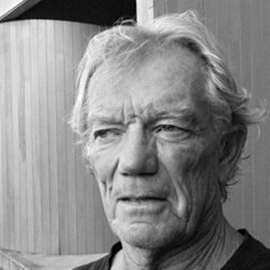 black and white headshot of a man with white hair
