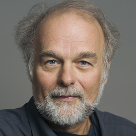 A headshot of a man with a beard.