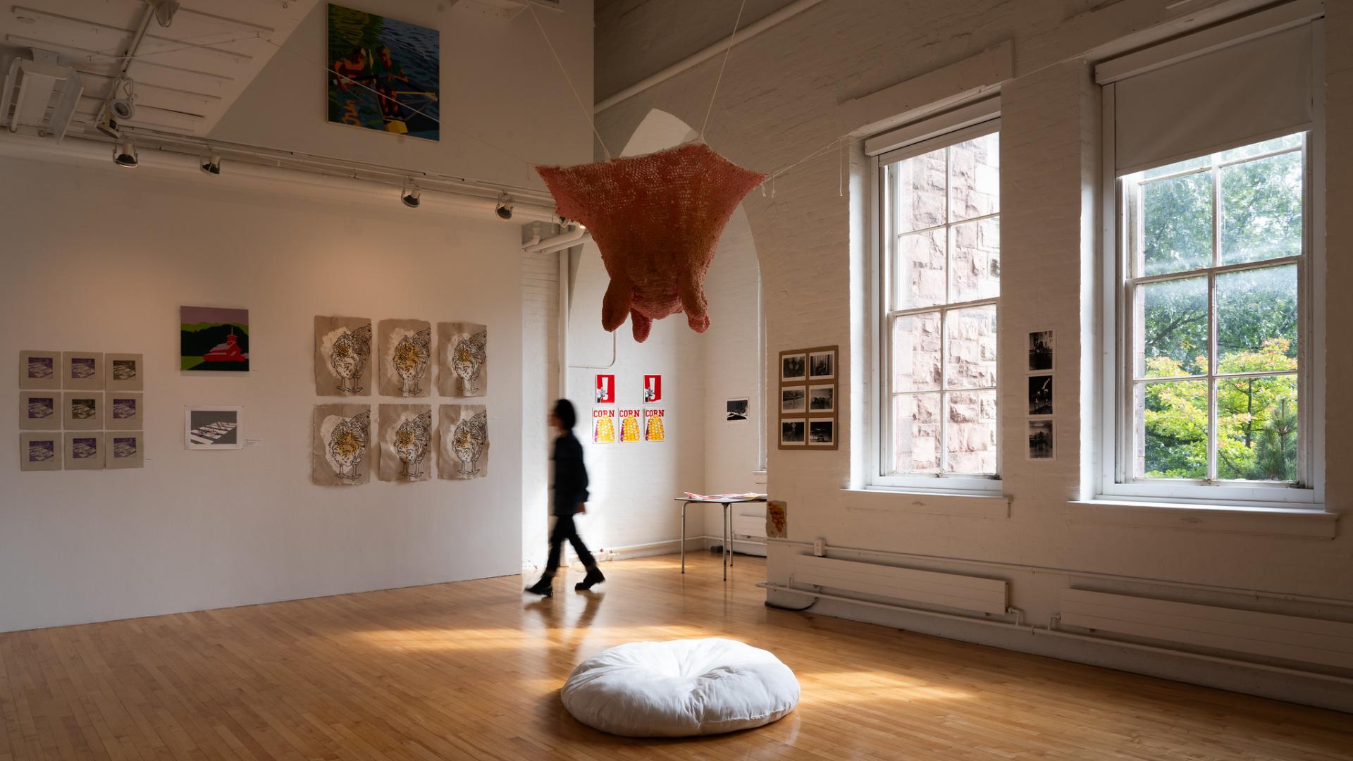 Person walking through a gallery exhibition