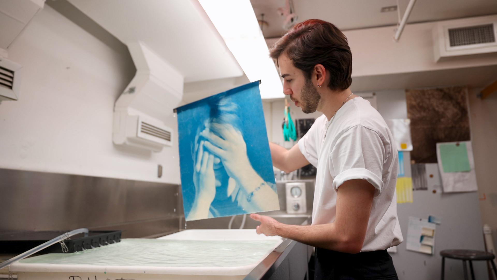 Student developing a color photograph