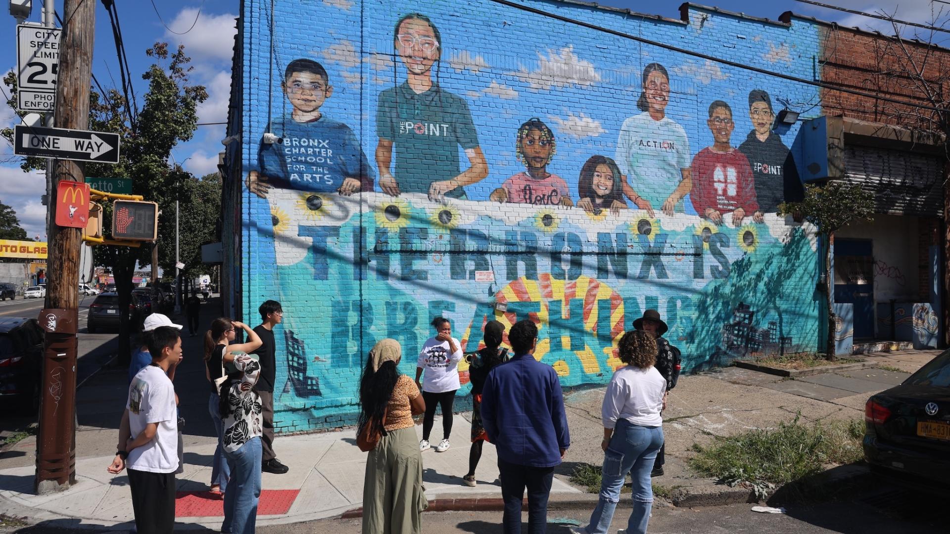 Painted mural of children on the side of a brick building in the Bronx