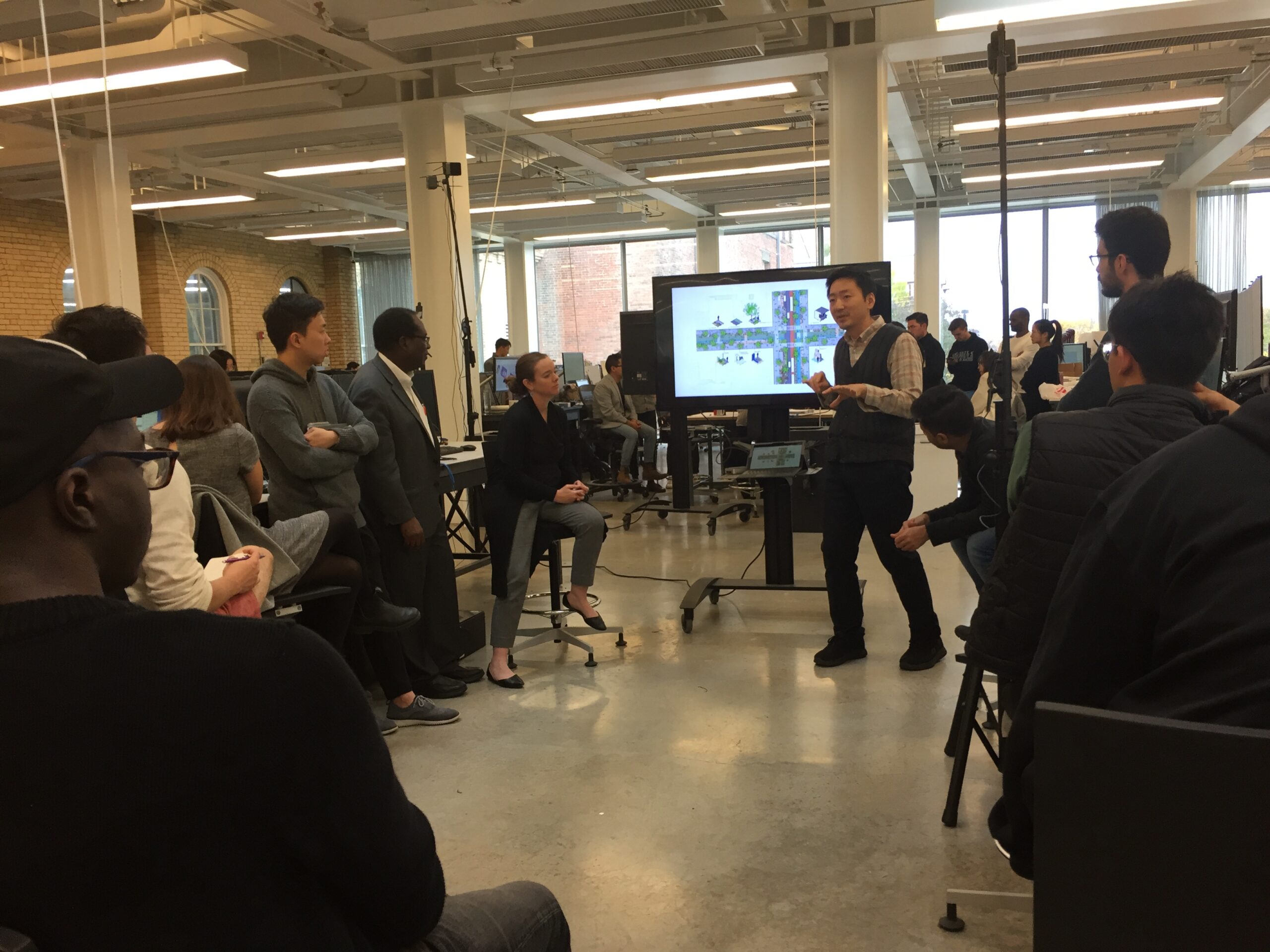 Male guest lecturer presents to students in VR studio