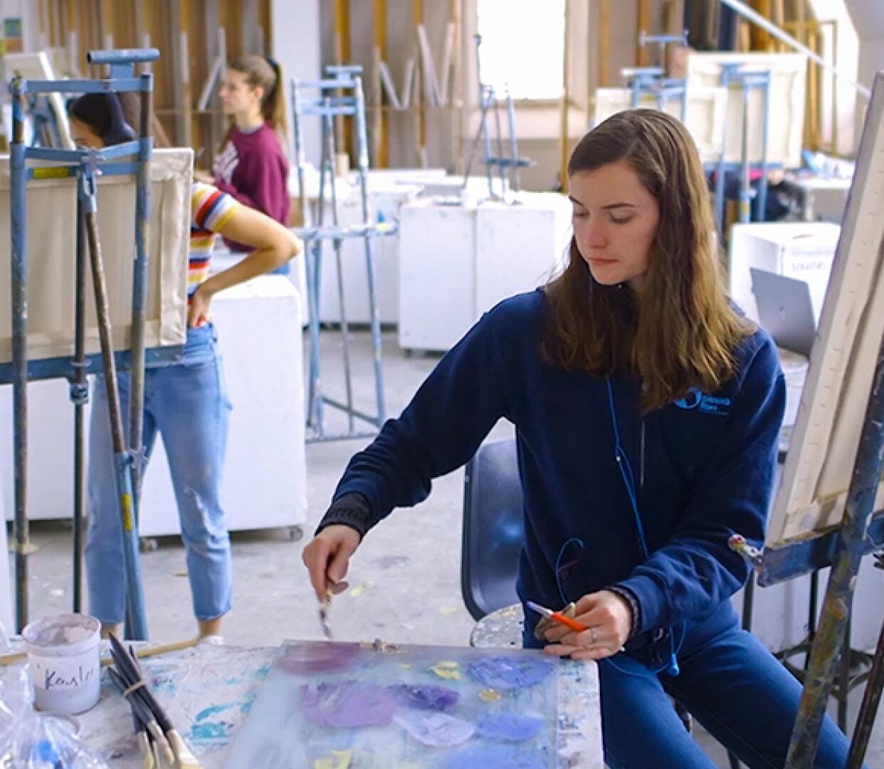 Students at work in a bright painting studio