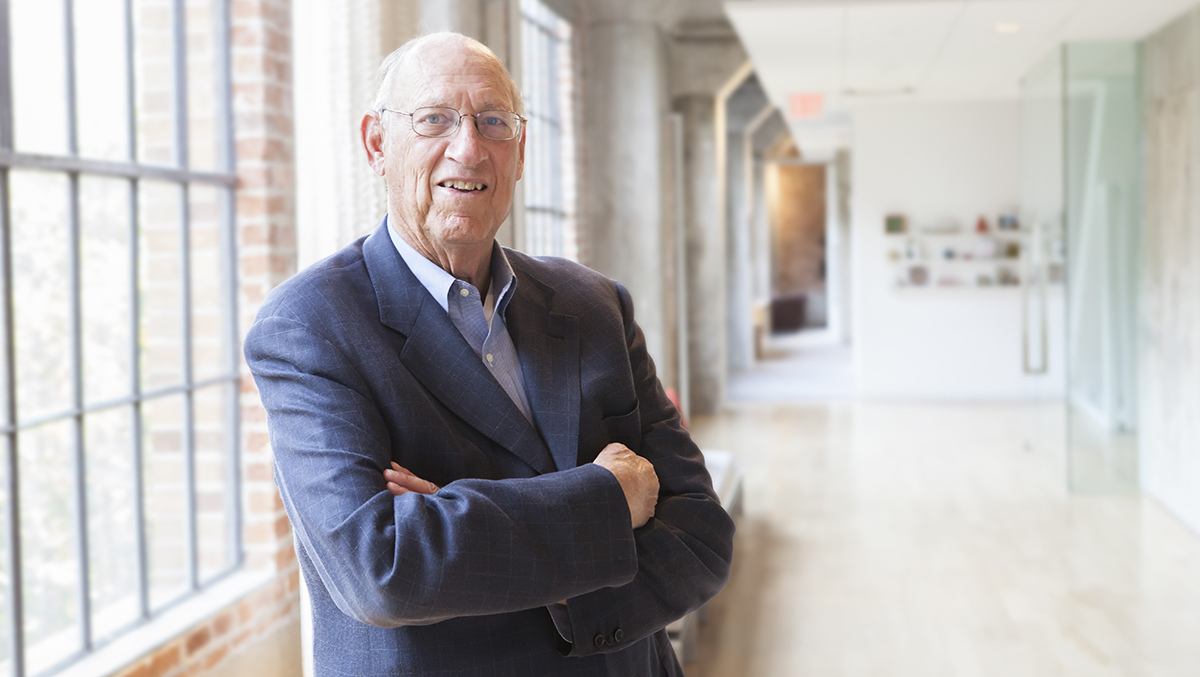 man in a blue jacket in a hallway
