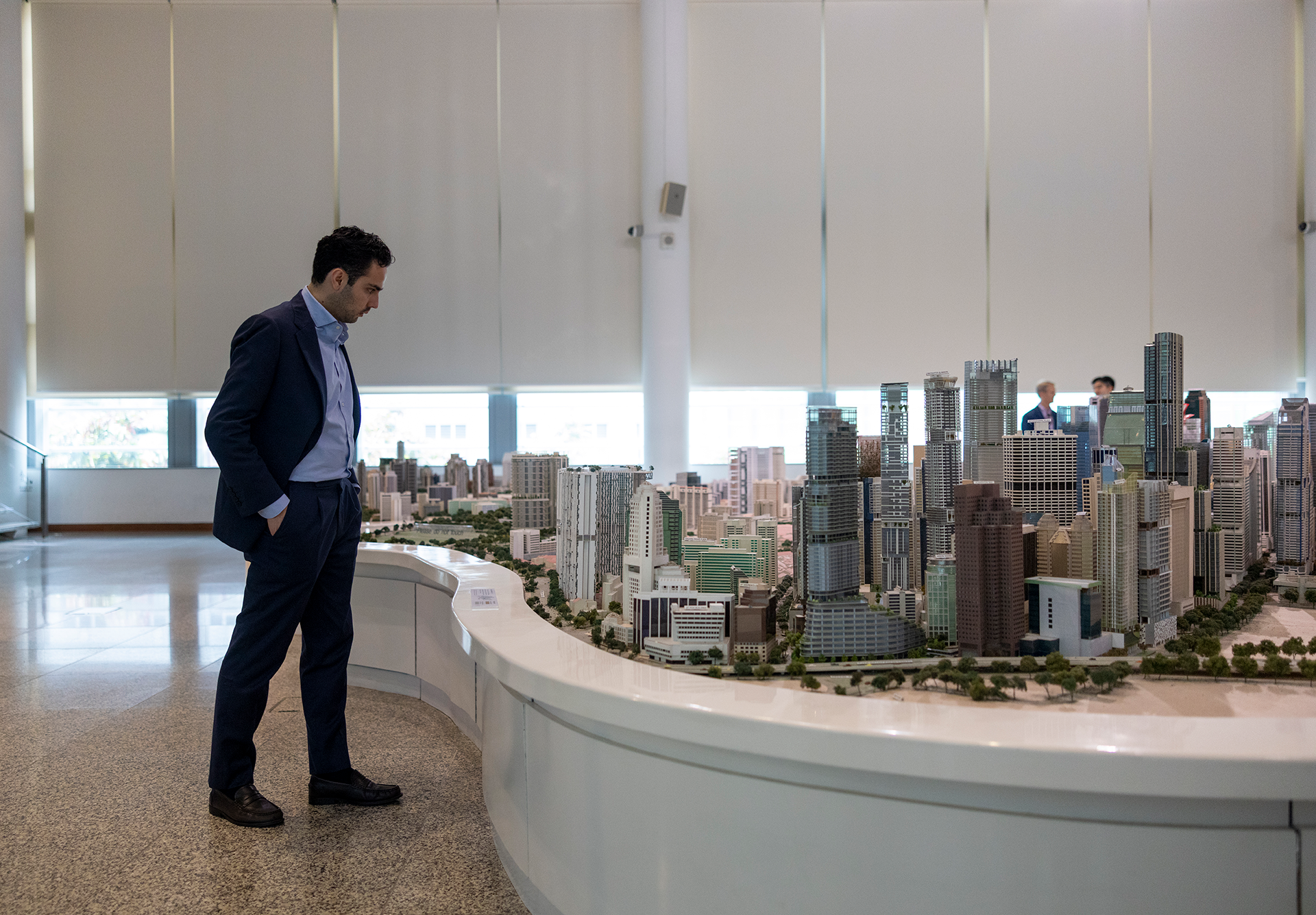 Student examining a large model of a city