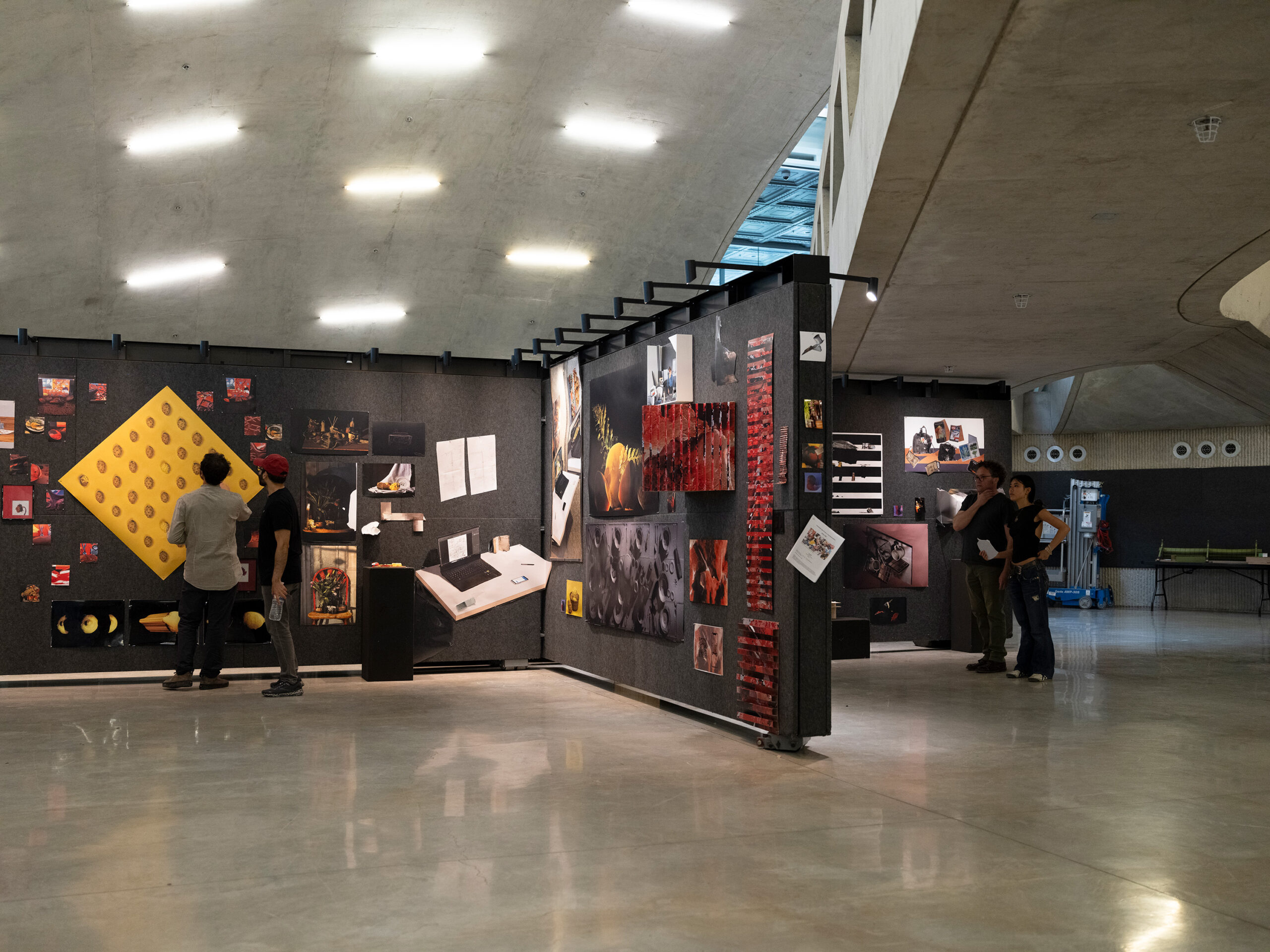people looking at work pinned to a gallery wall