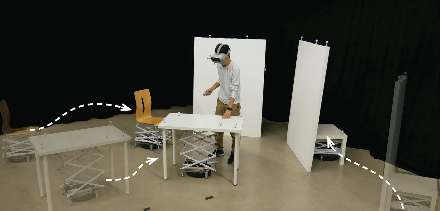 A person wearing a Virtual Reality Headset surrounded by pieces of furniture. The image was edited to add arrows pointing to each piece of furniture.