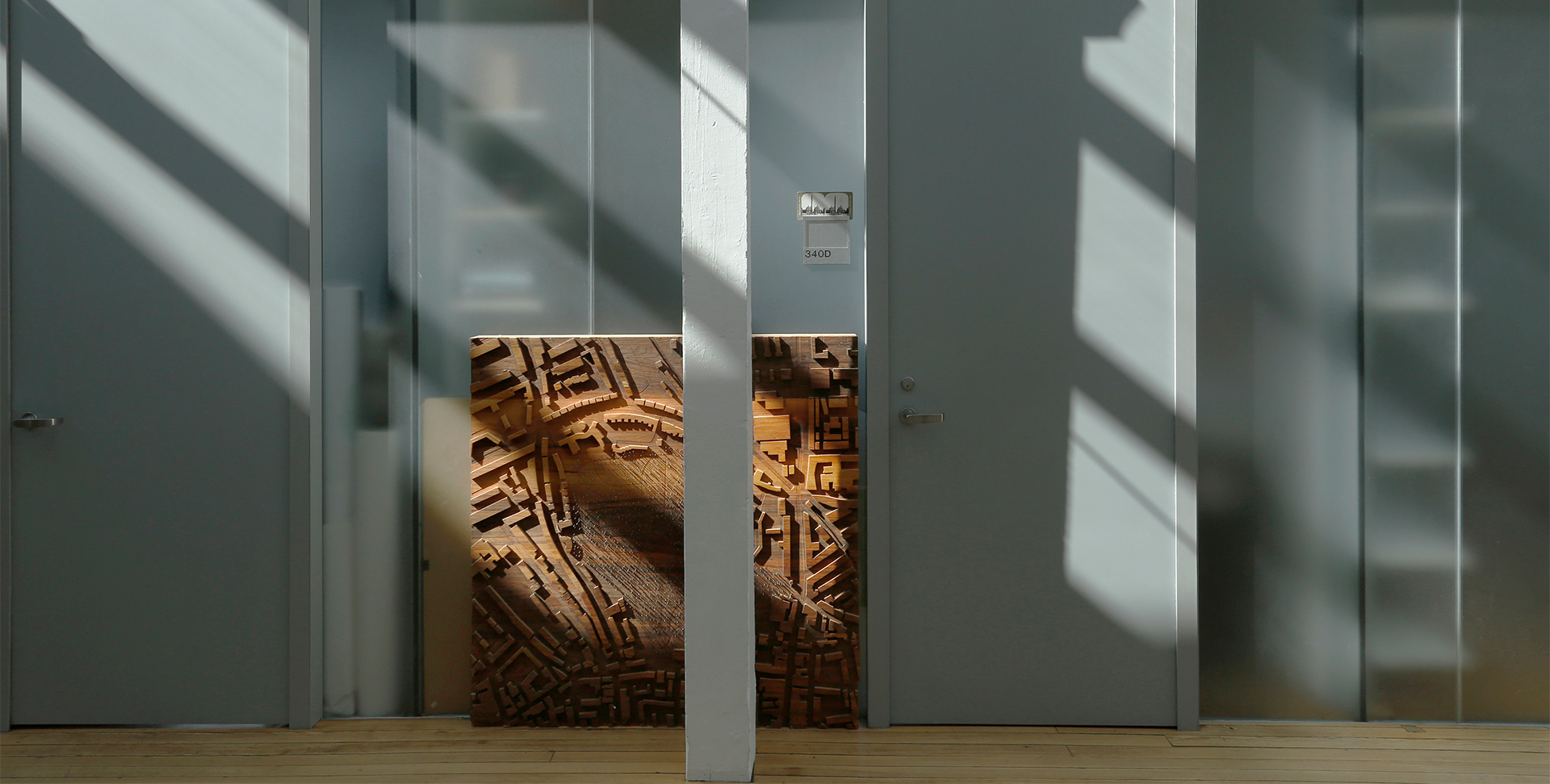 Wooden model propped up against a door