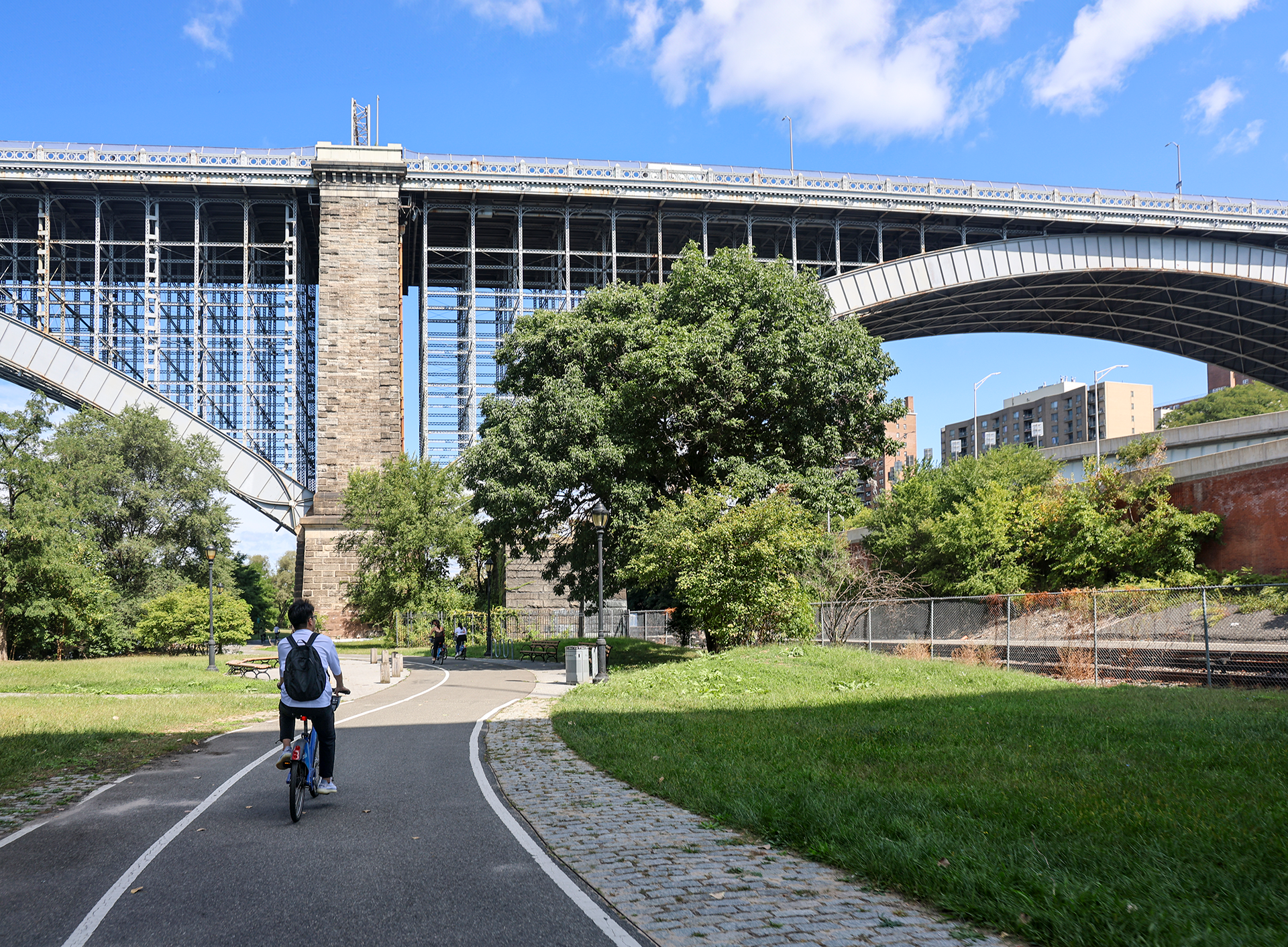 Person riding a bike along an urban path