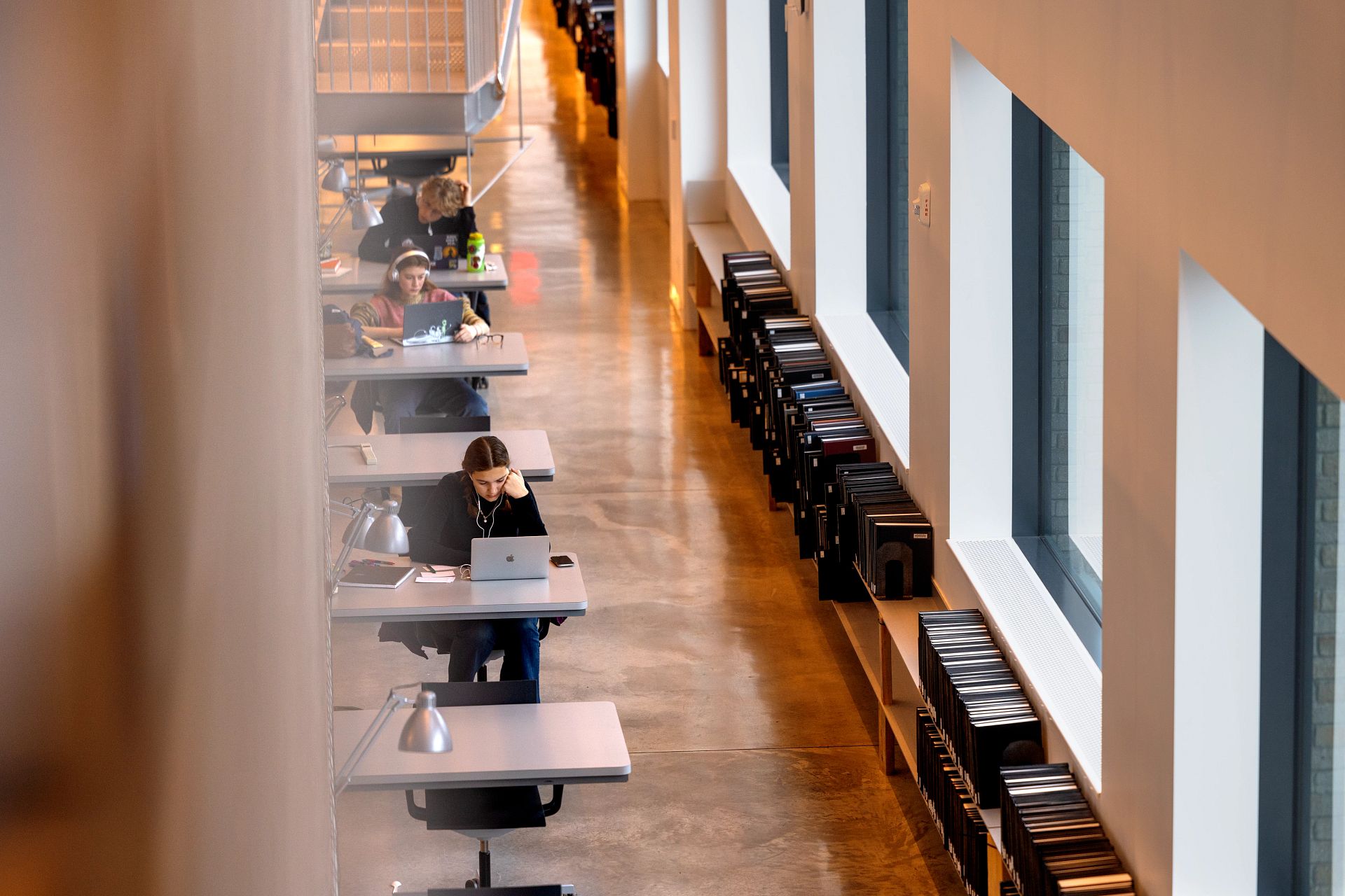 students working on laptops at library carrels